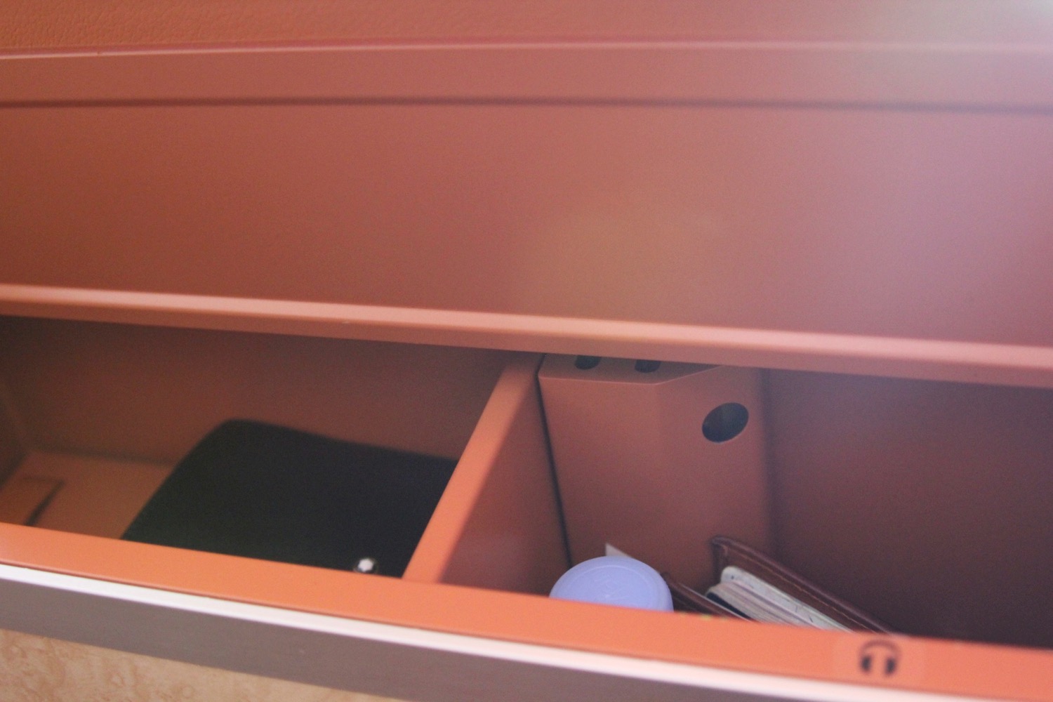 a drawer with a shelf and a folder and a book