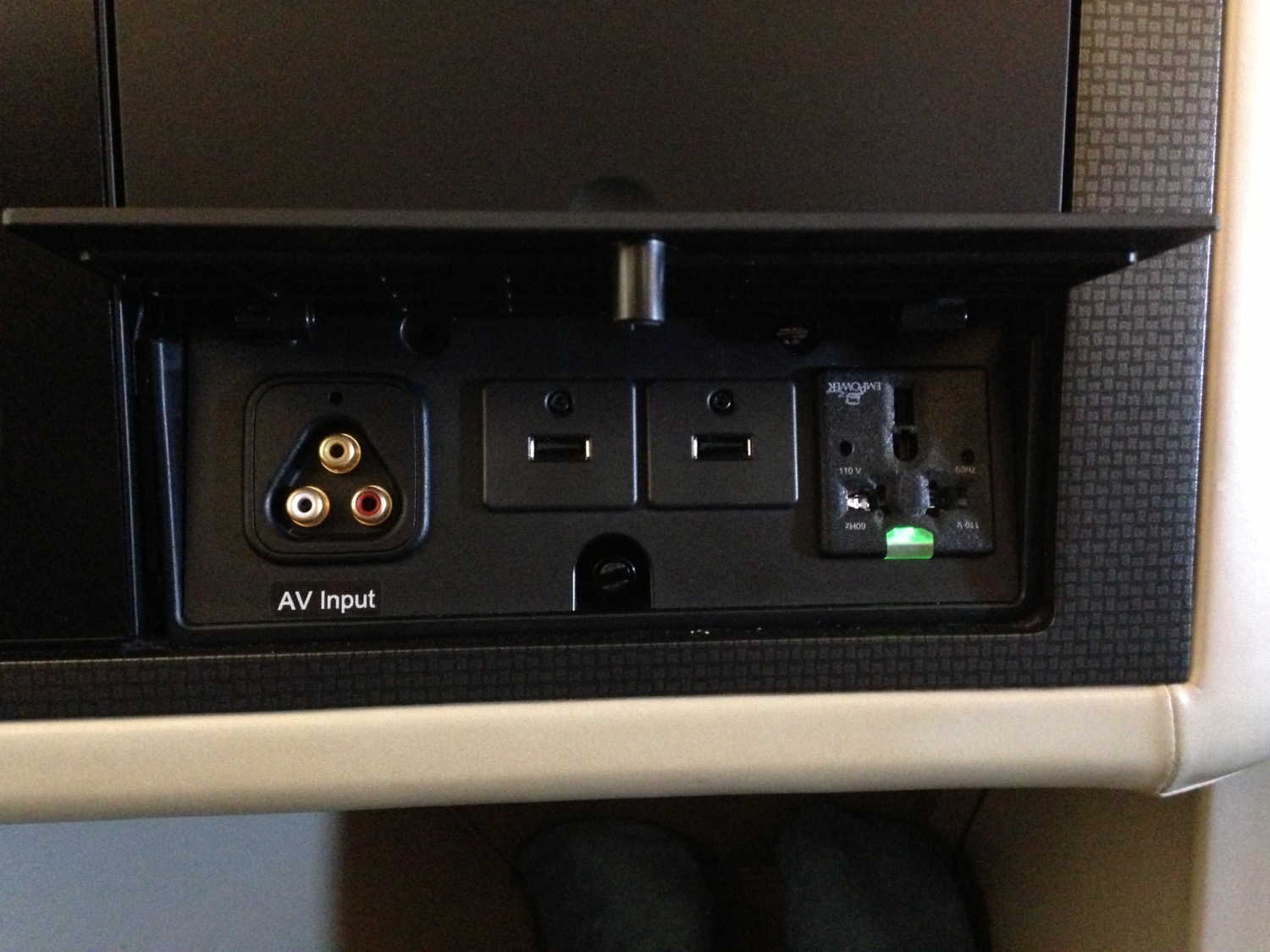 a black rectangular device with plugs and ports