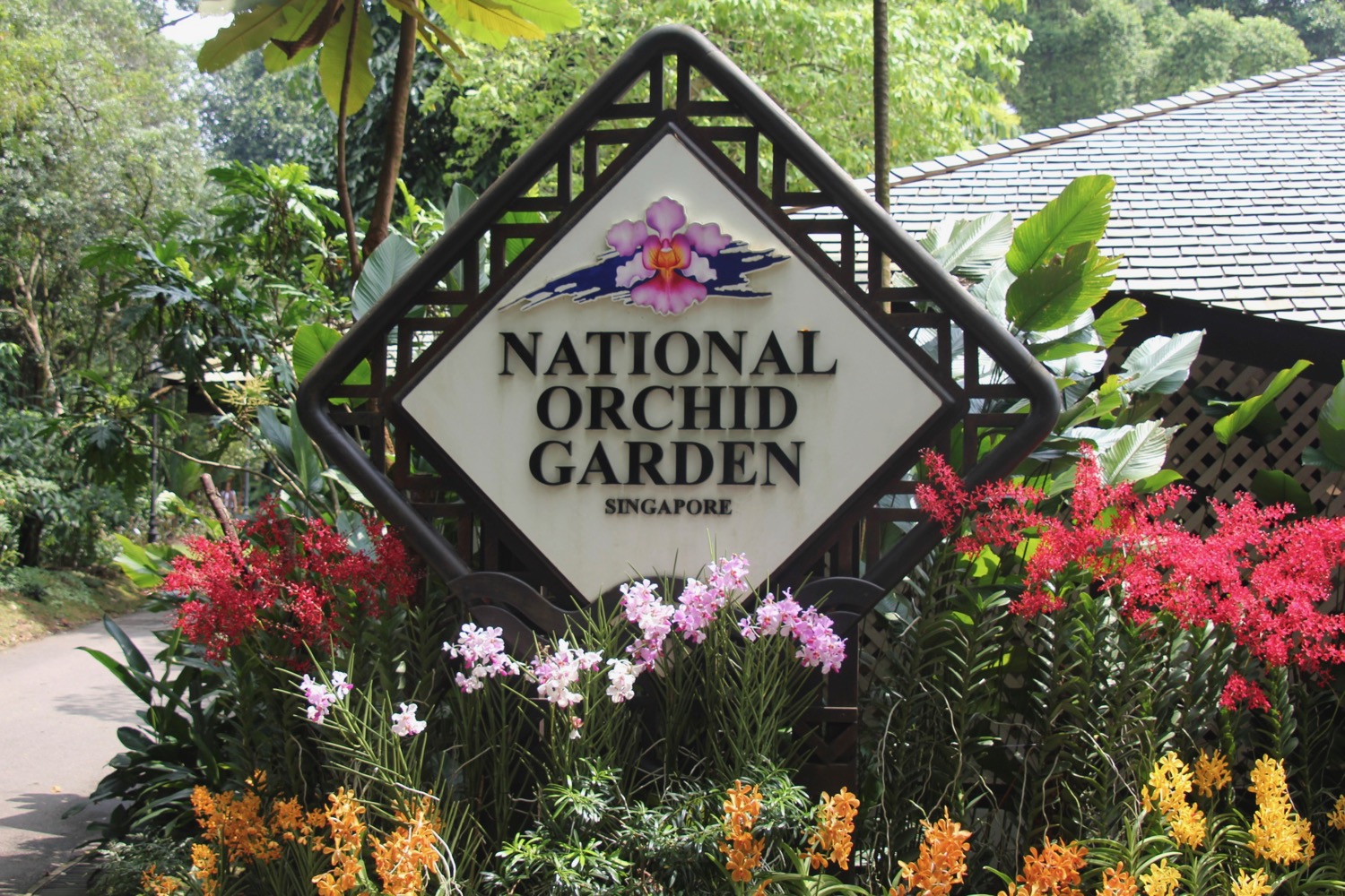 a sign in the middle of a garden