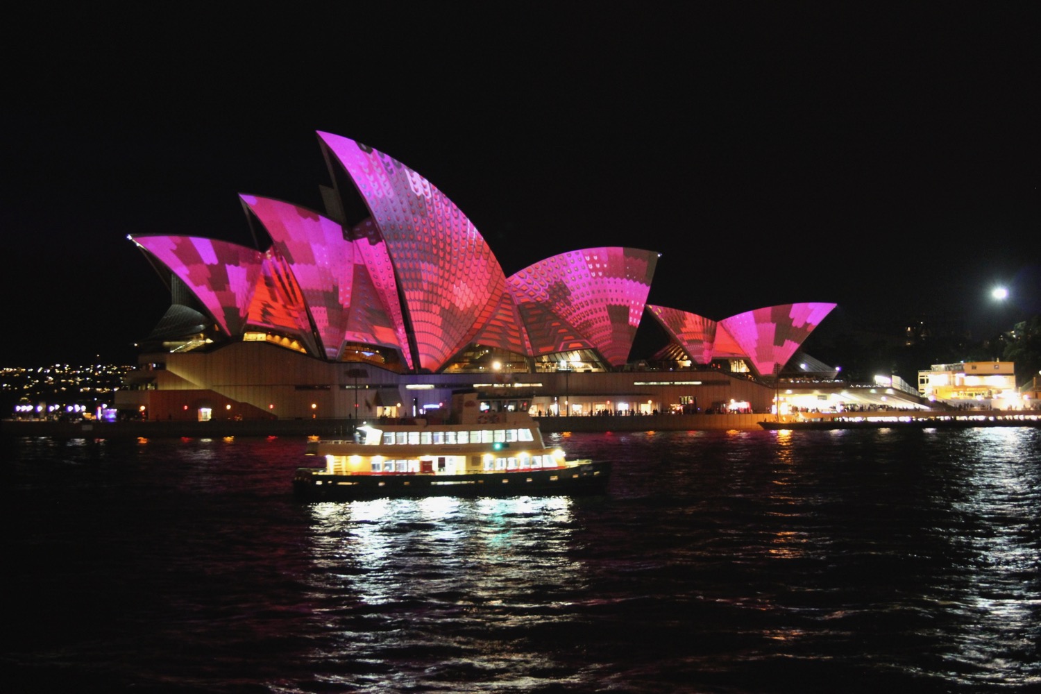 Sydney Opera House with pink lights on it
