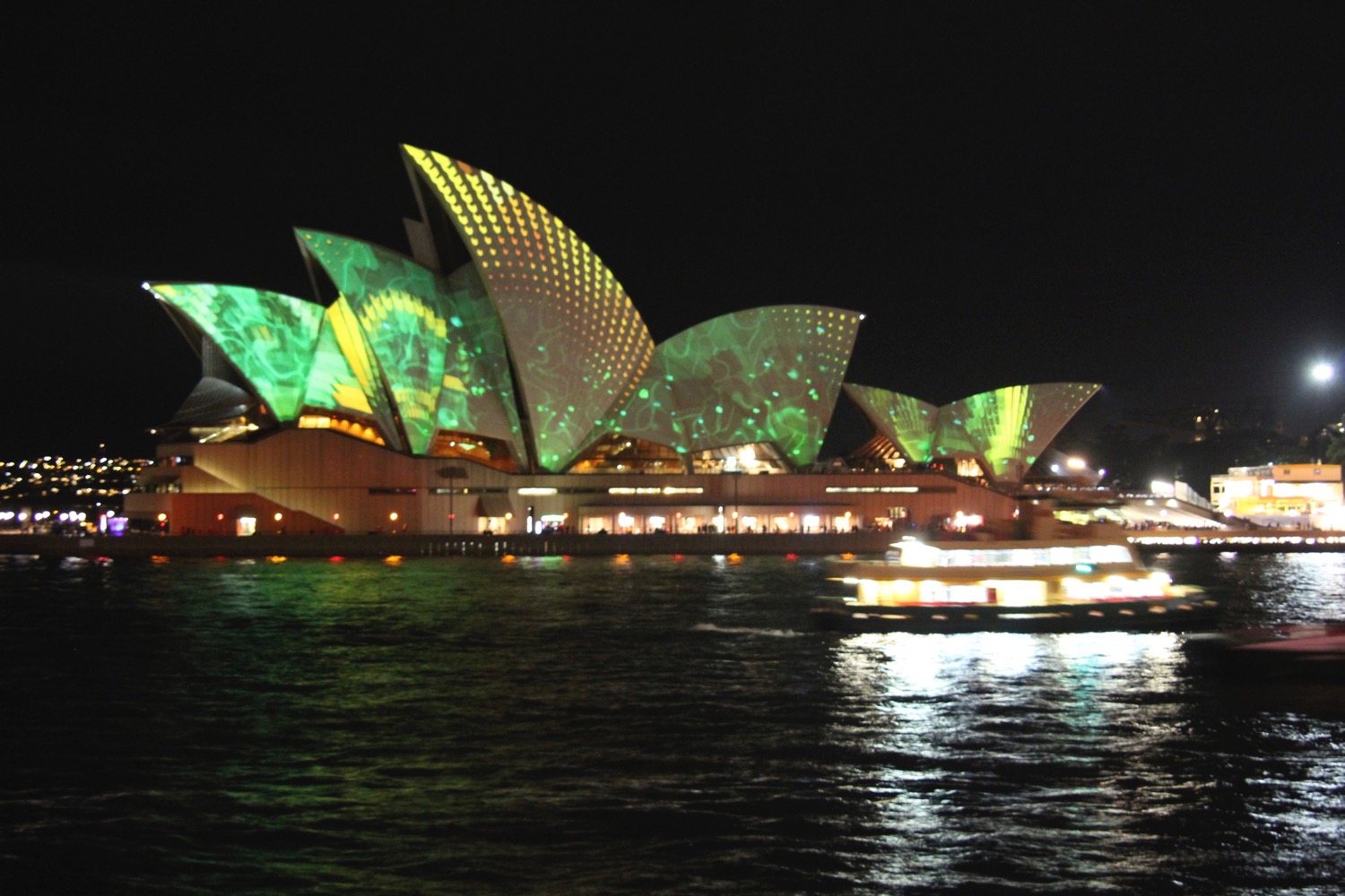 Sydney Opera House with green lights on it