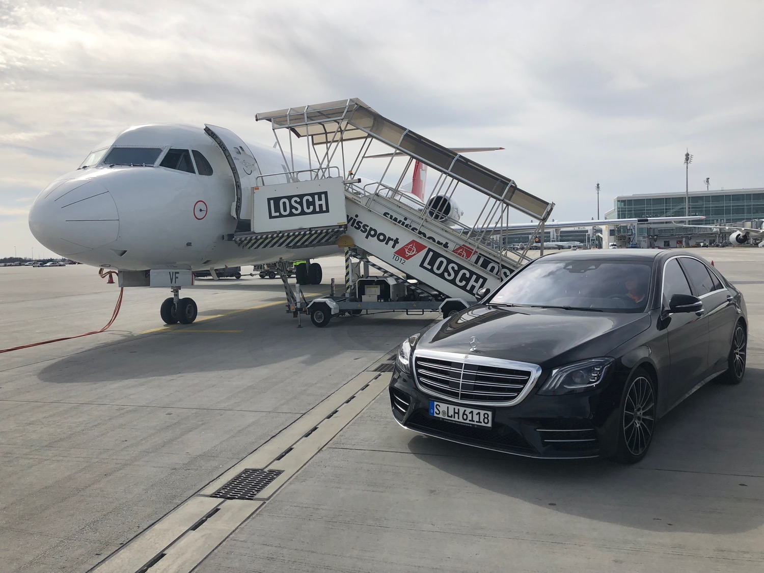 a car parked next to a jet
