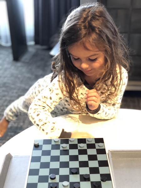 Lucy enjoyed playing checkers with her own rules.