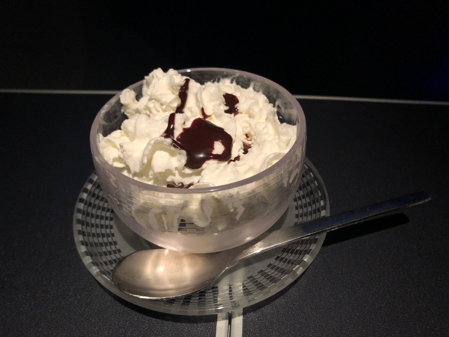 a bowl of whipped cream and chocolate syrup