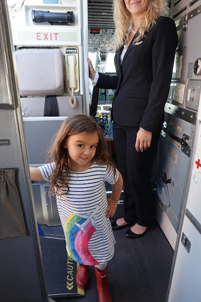 The flight attendant let Lucy pretend she was part of the crew. 