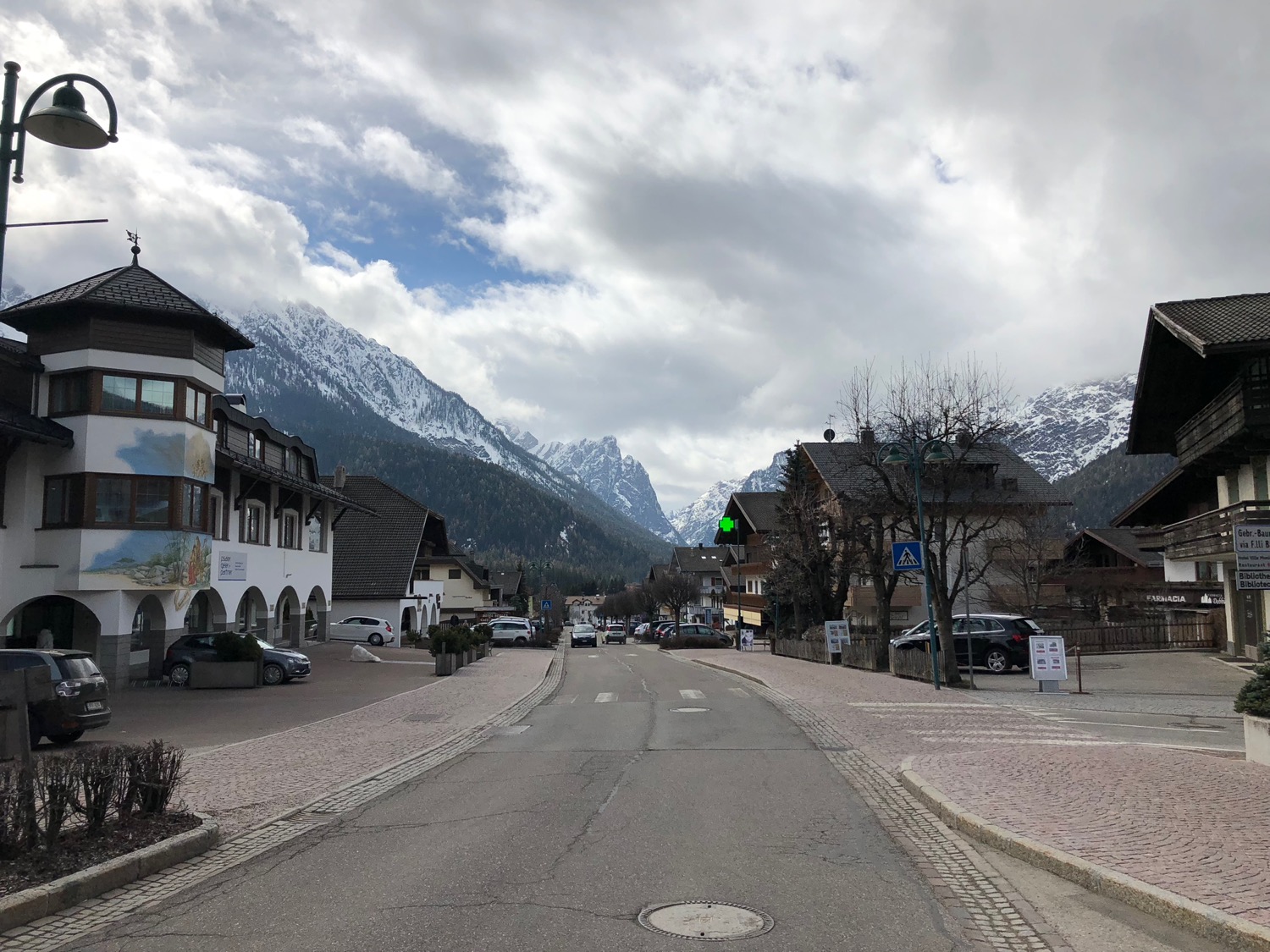 a street with buildings and mountains in the background