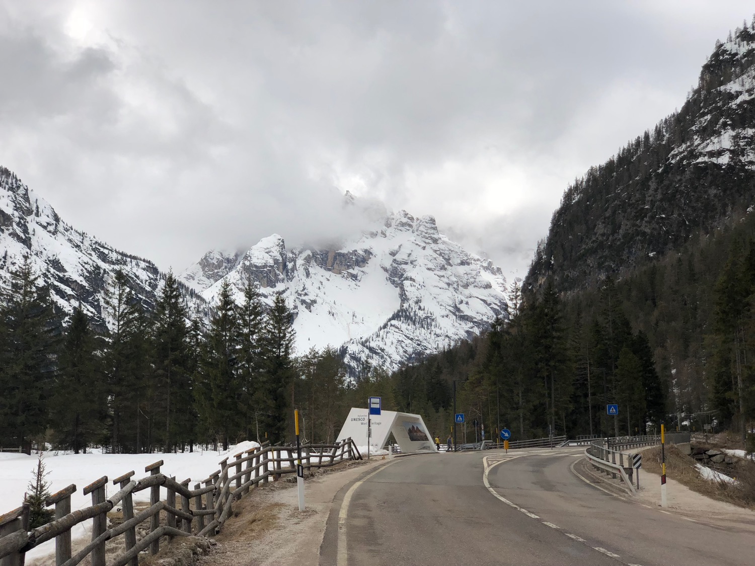 a road with a snowy mountain in the background