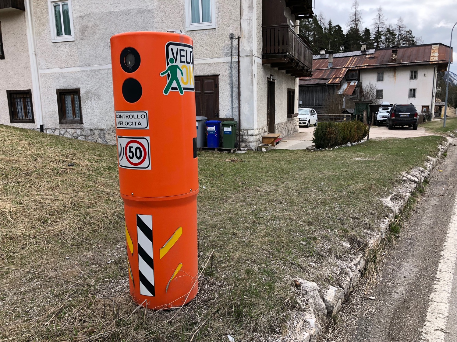 an orange pillar with stickers on it