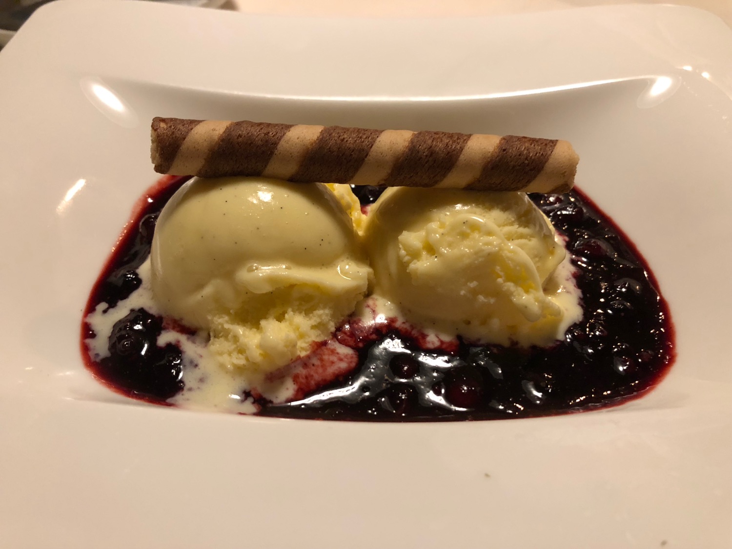 a plate of ice cream and sauce