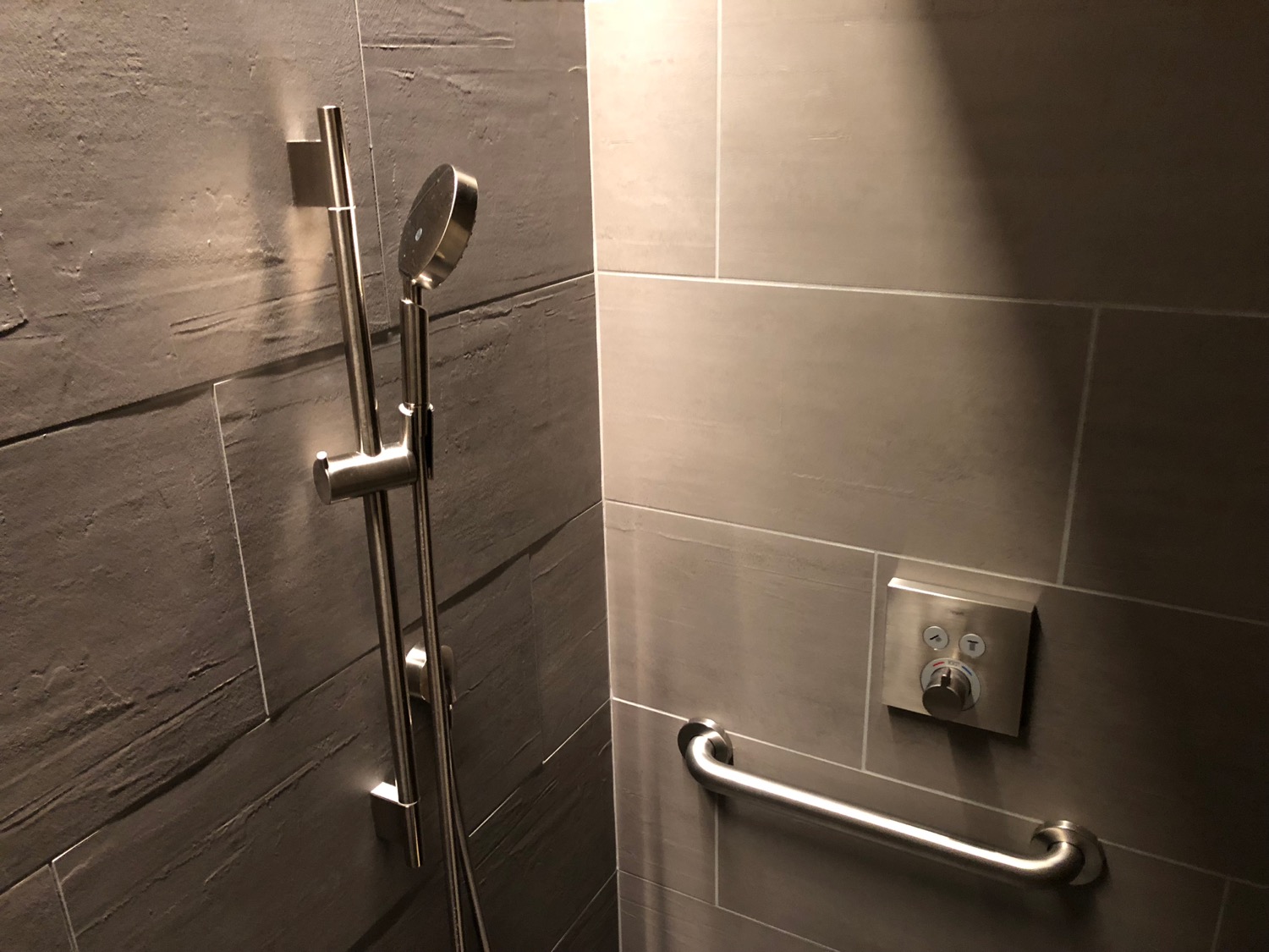 a shower with a hand held shower head