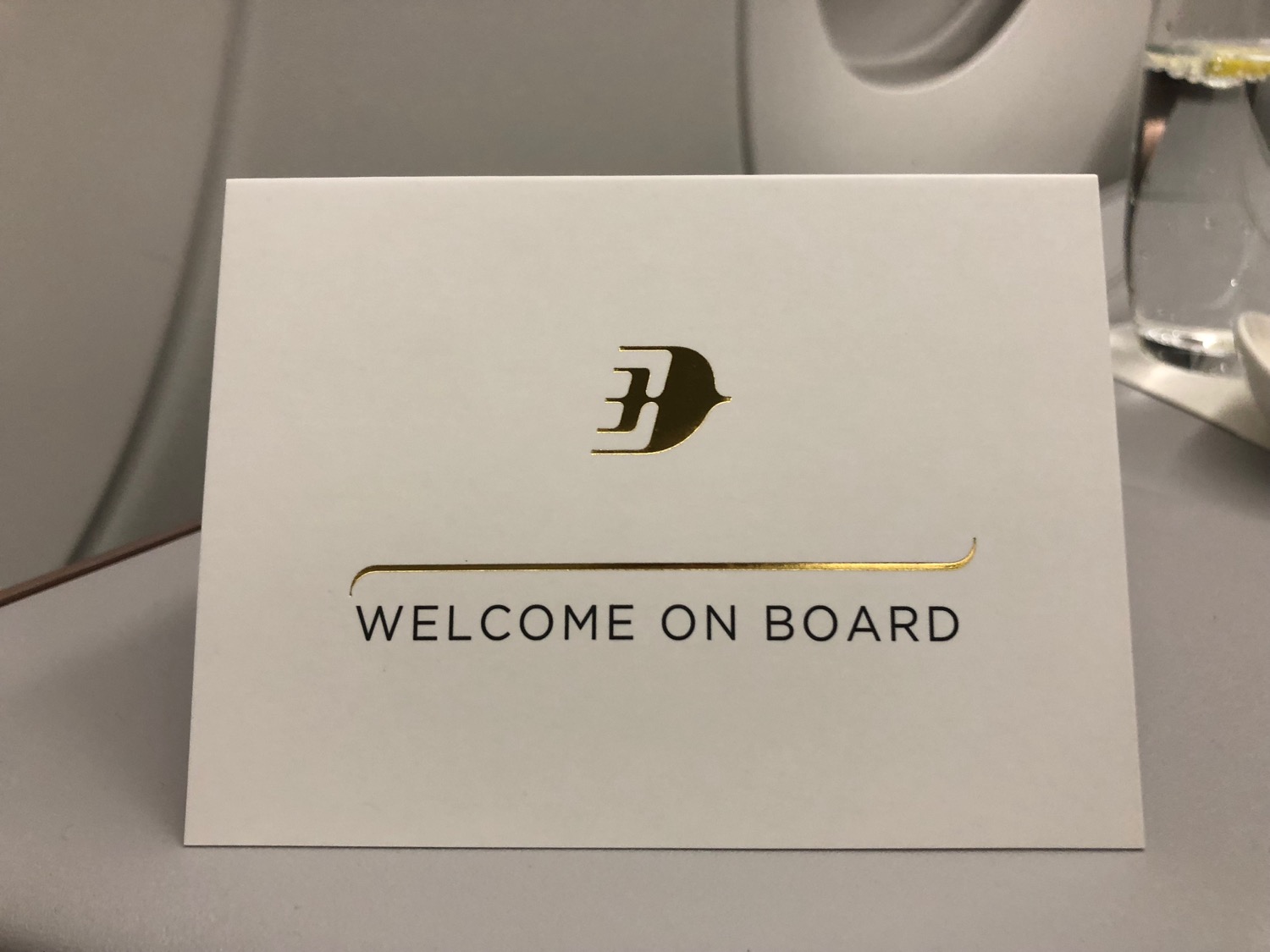 a white card with gold text on it