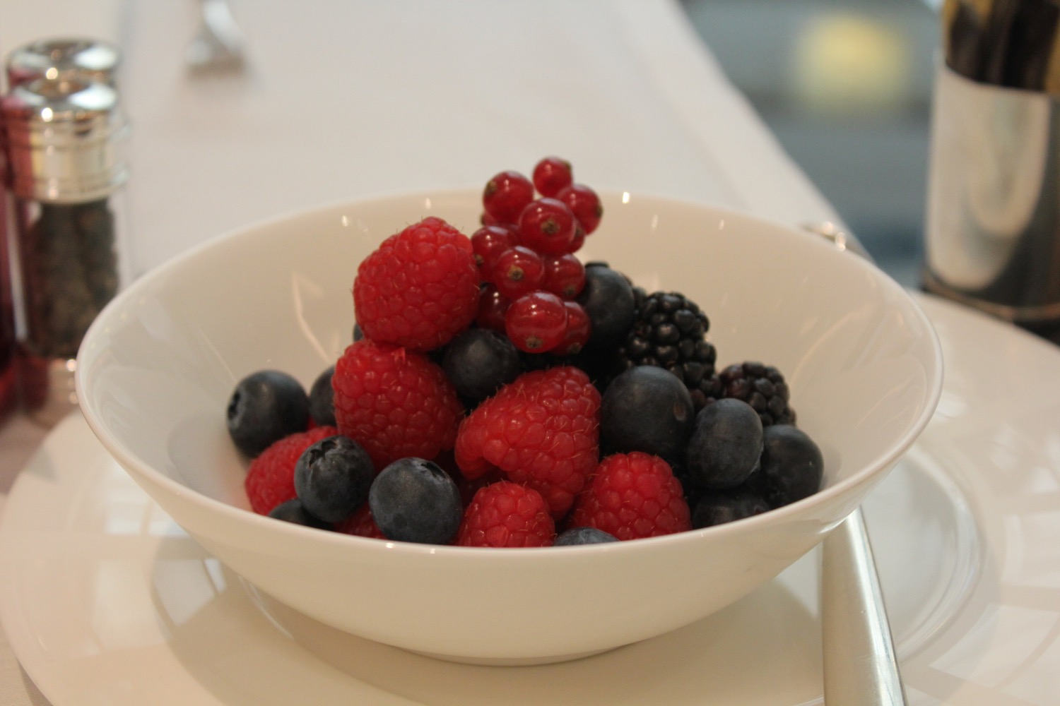 a bowl of berries on a table