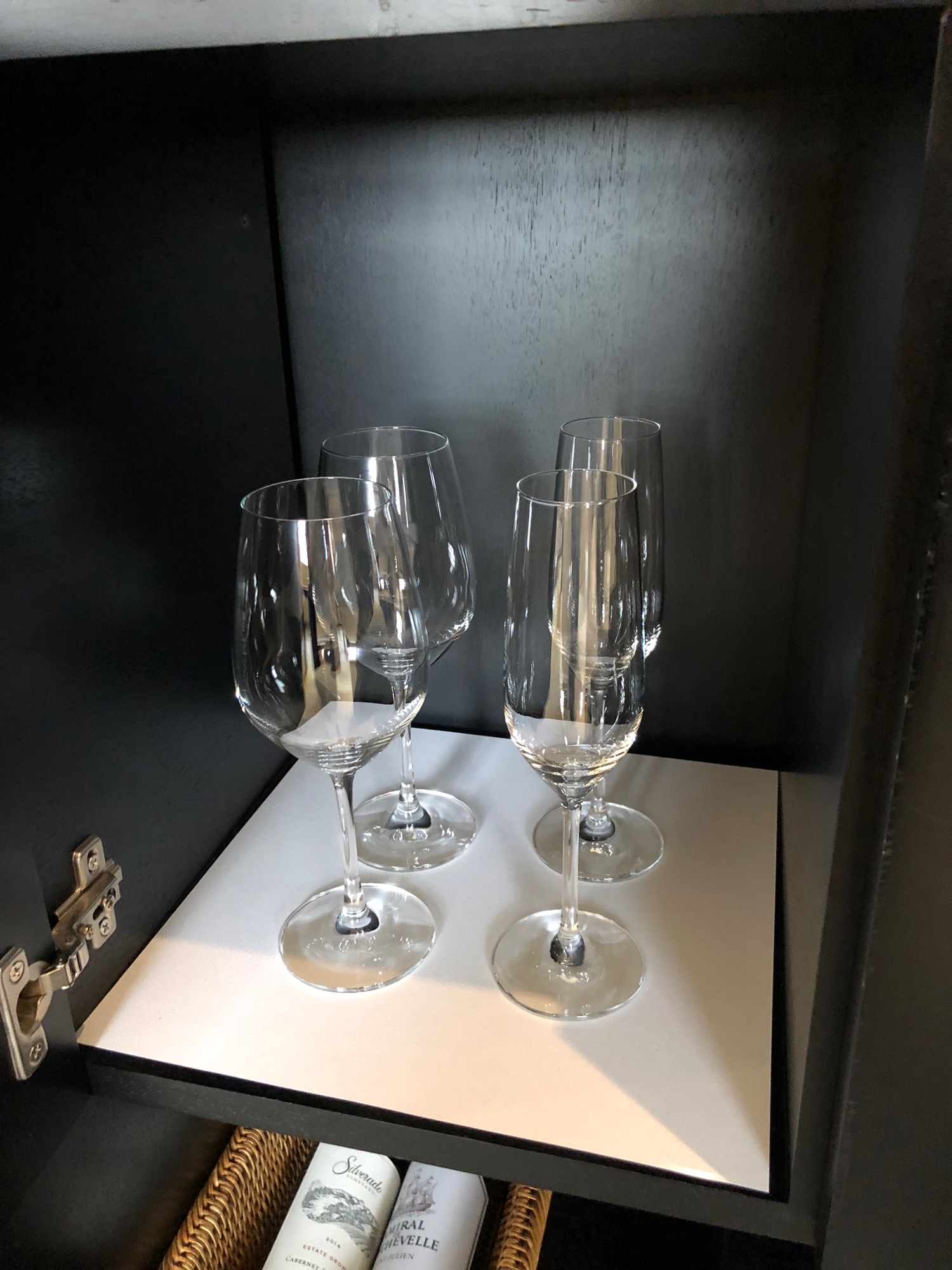 a group of wine glasses on a white surface