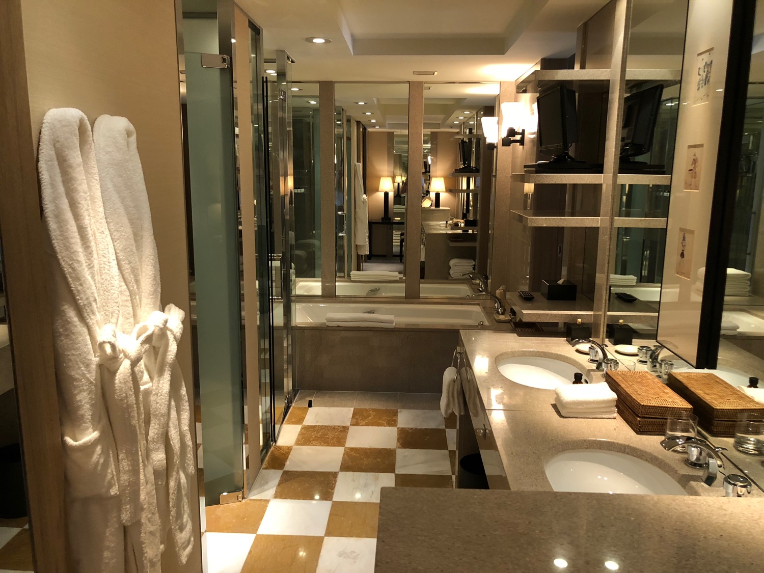 a bathroom with a white robe and a mirror