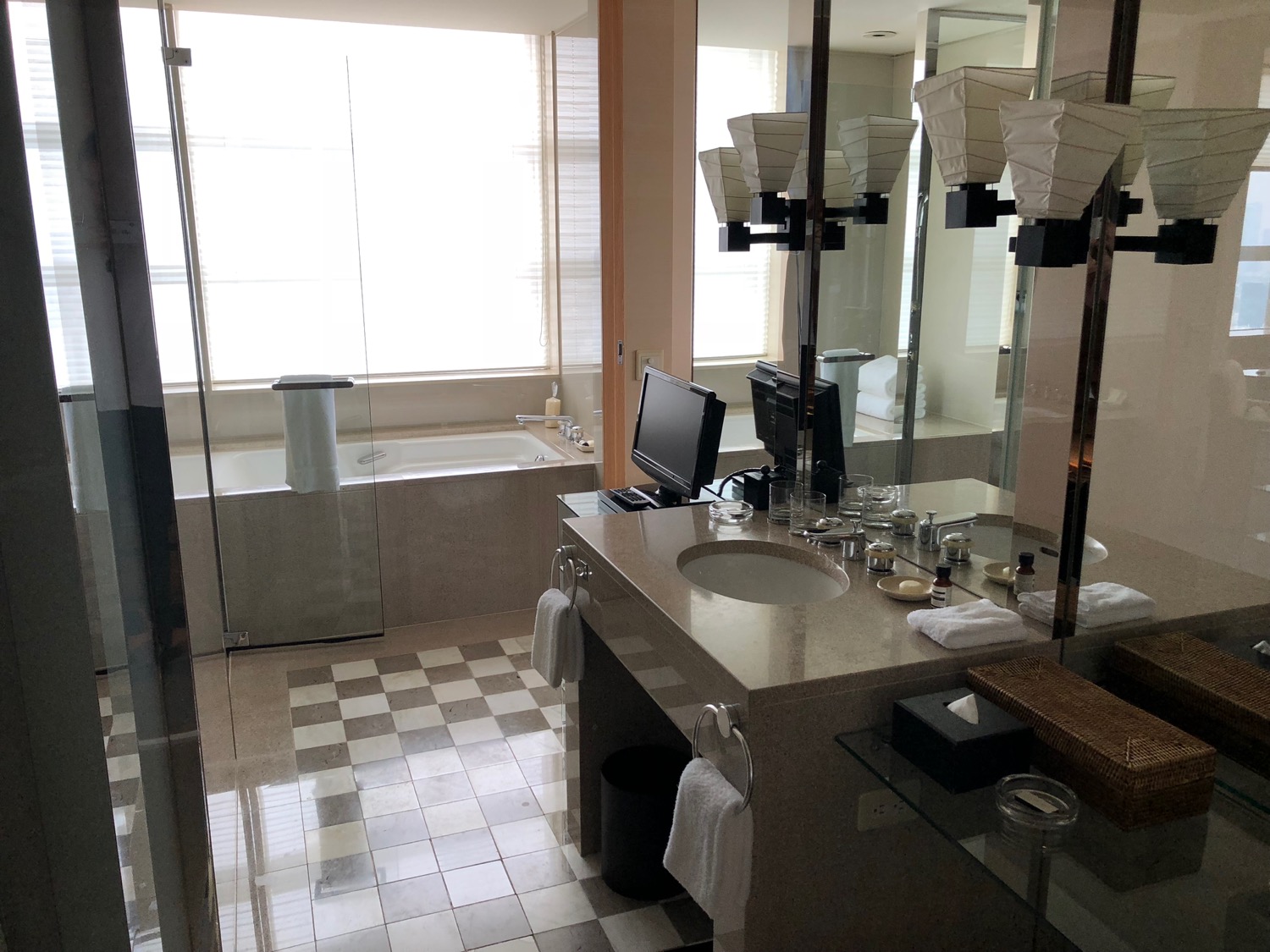 a bathroom with a computer and a bathtub
