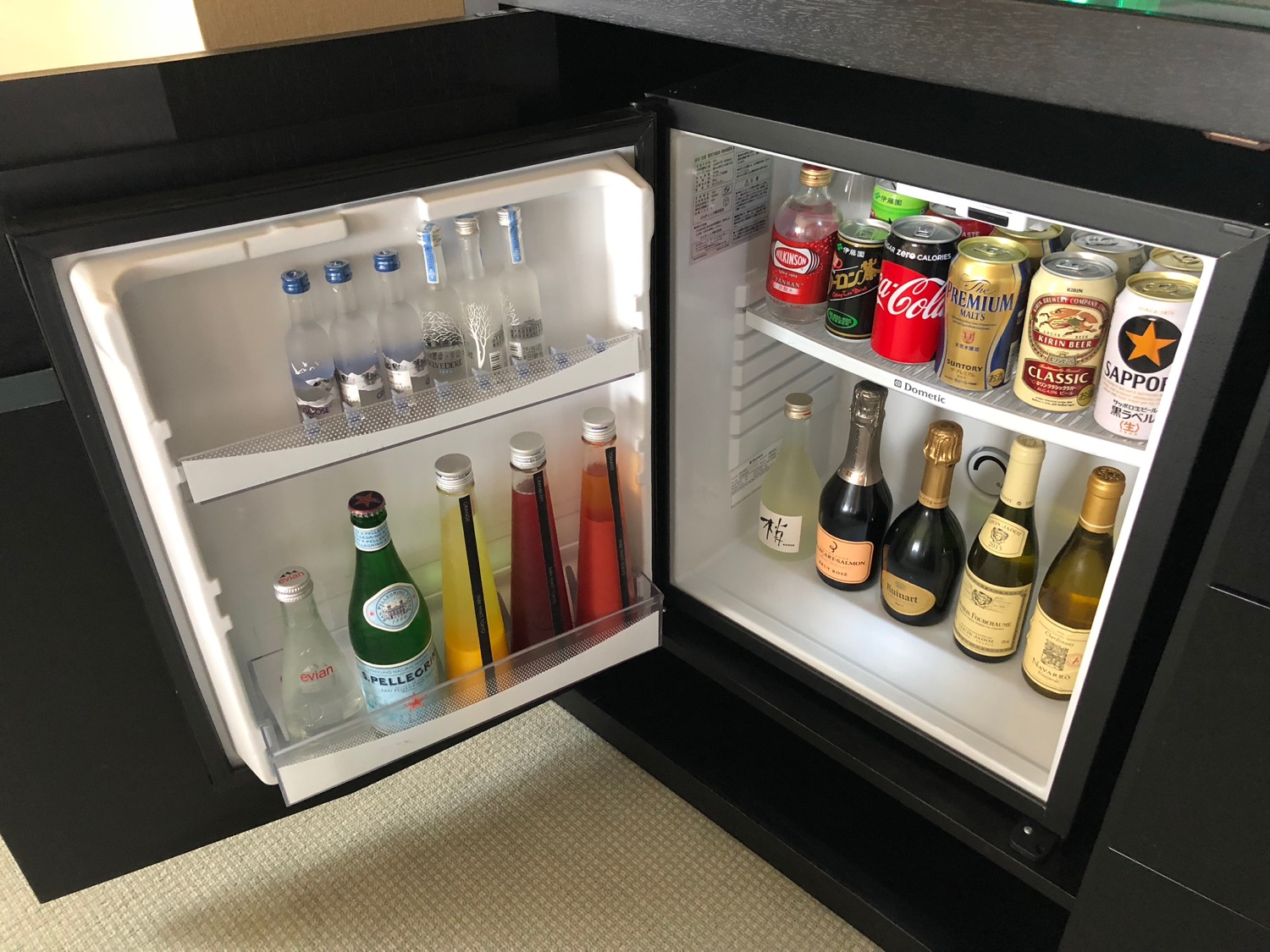 a mini fridge with bottles of alcohol and soda