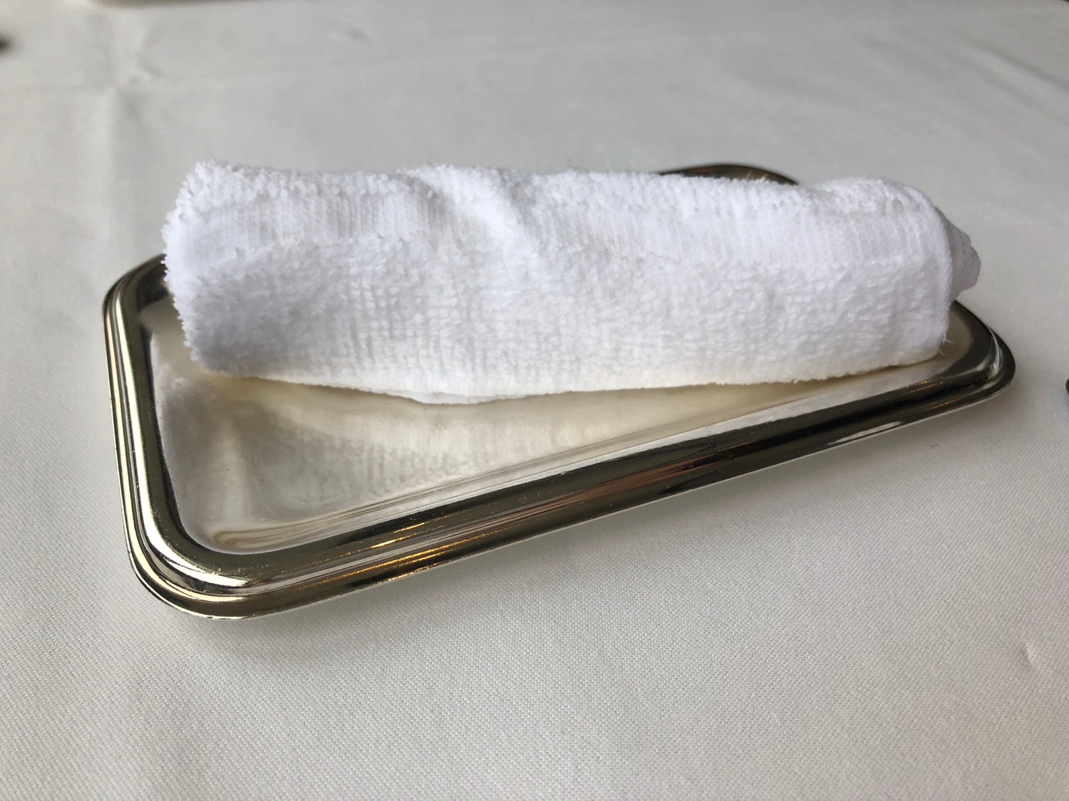 a white towel on a metal tray