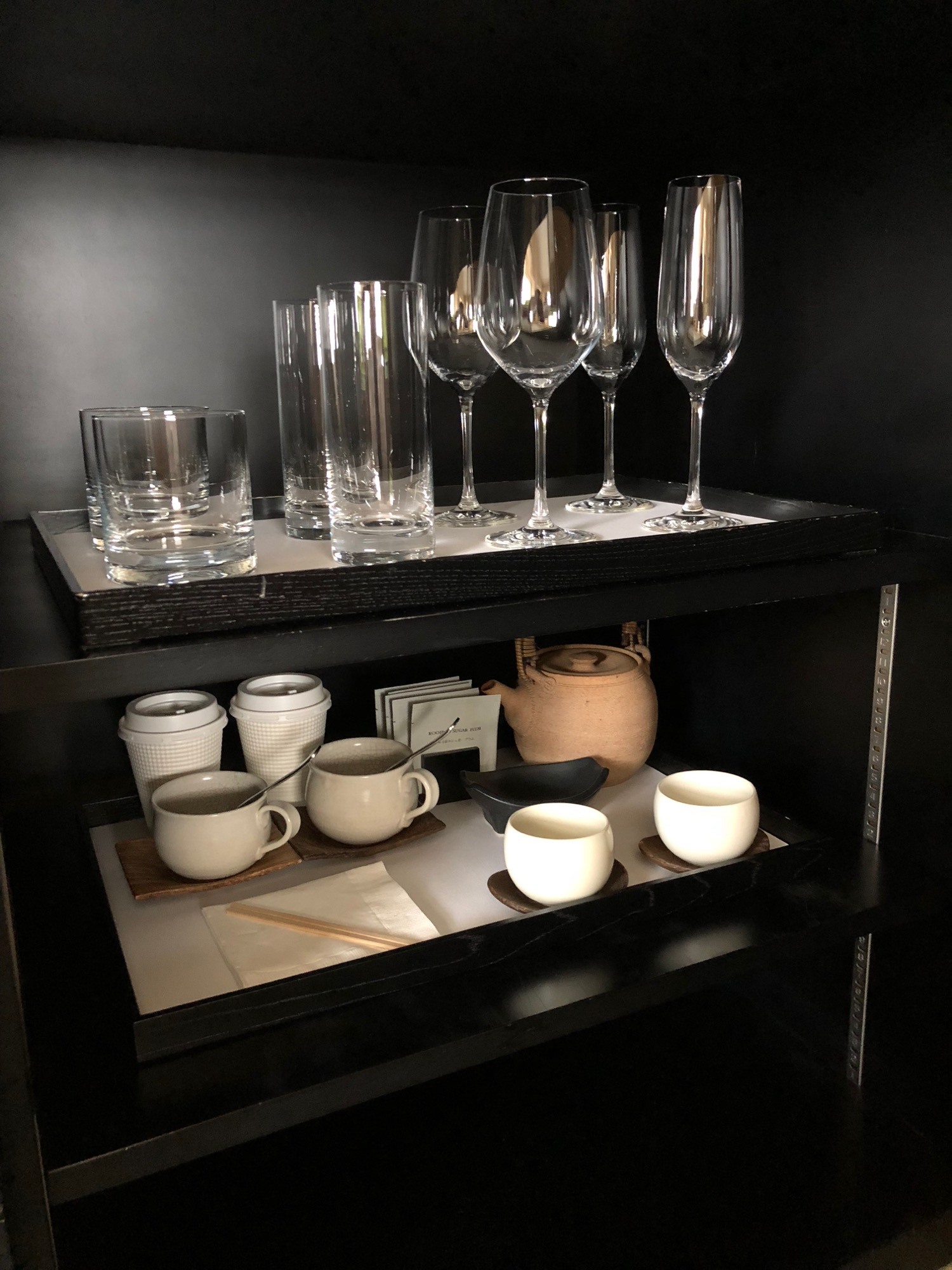 a shelf with glasses and cups on it