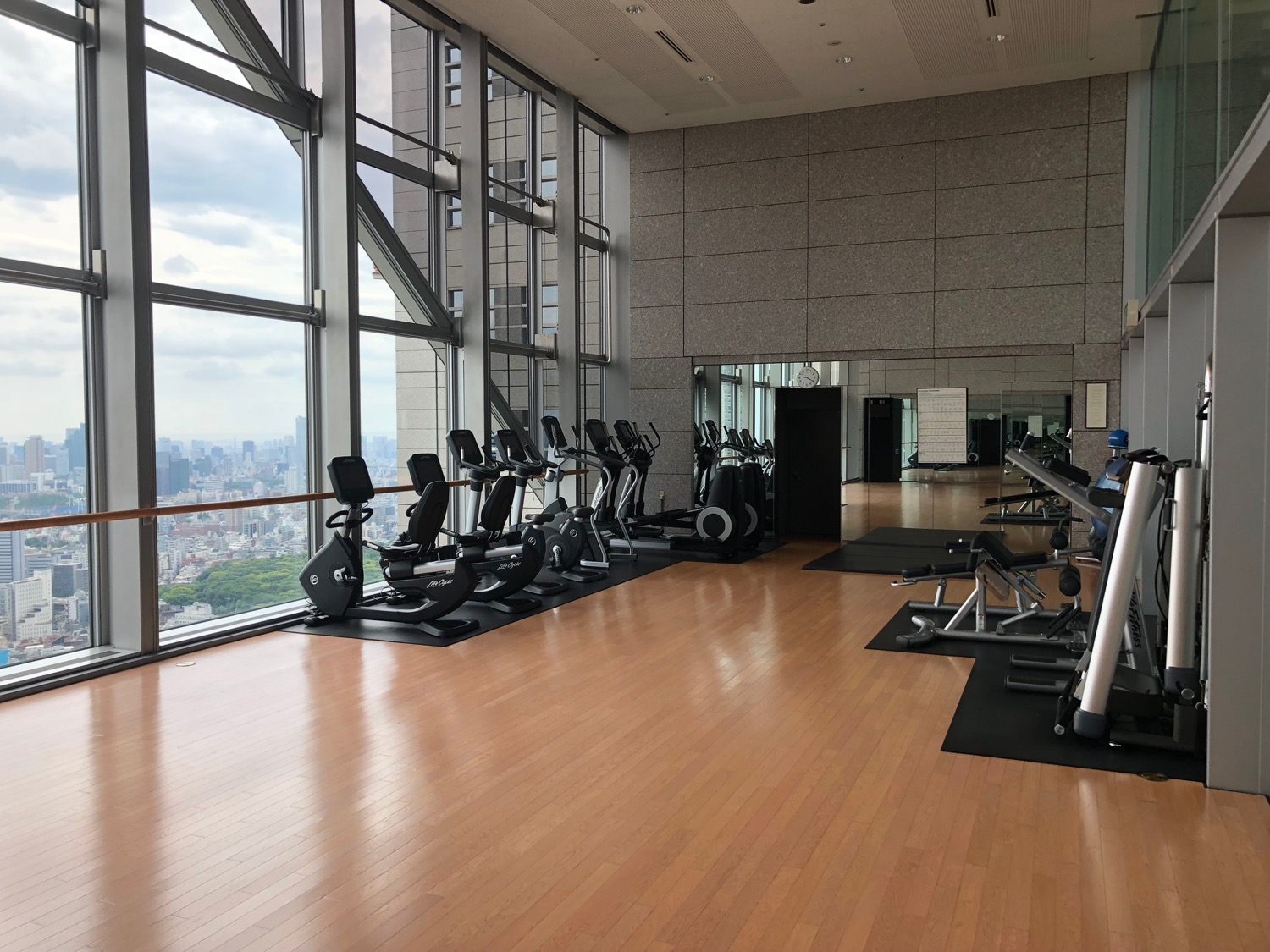 a large room with exercise equipment and a large window