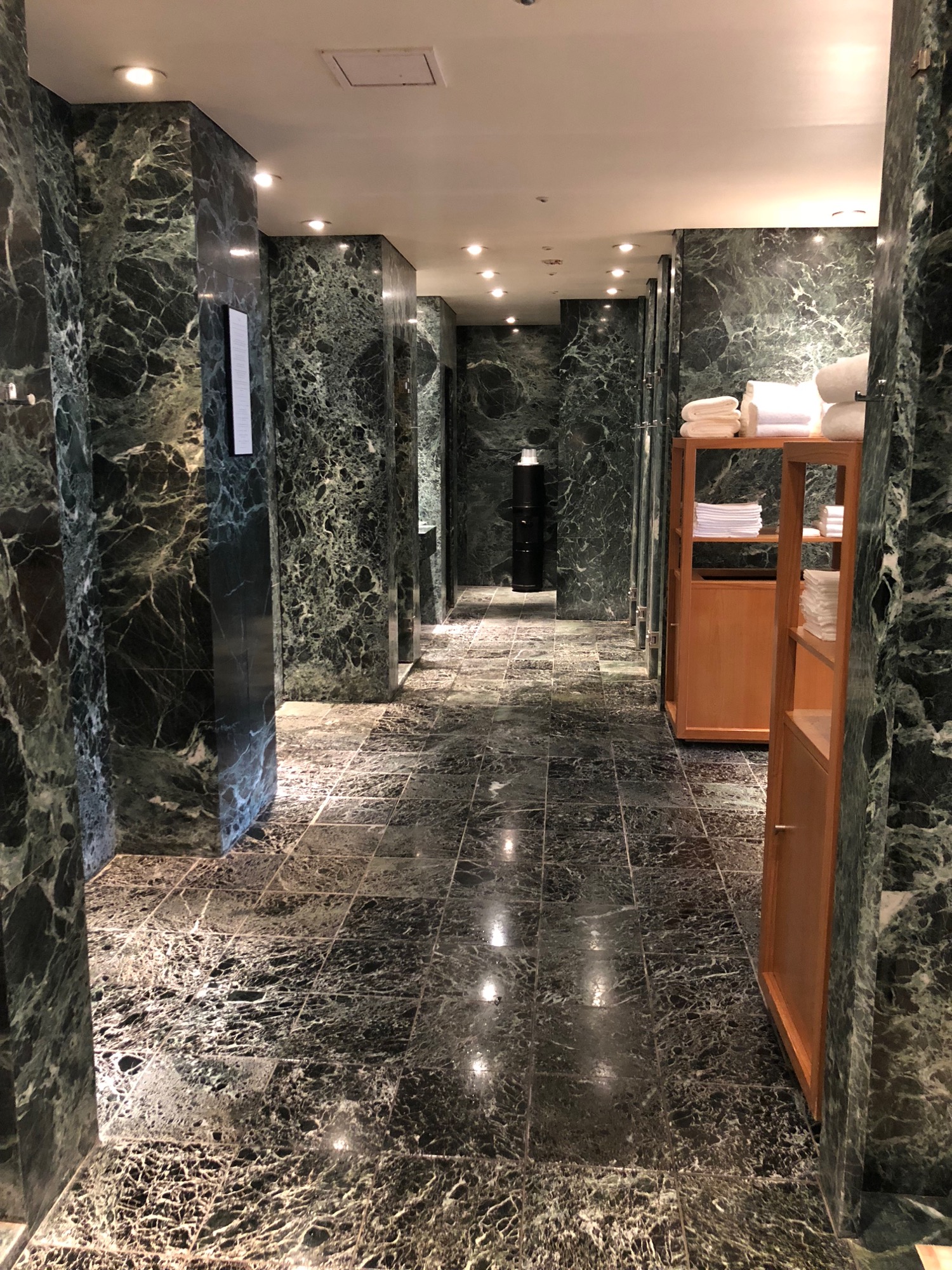 a bathroom with marble walls and shelves