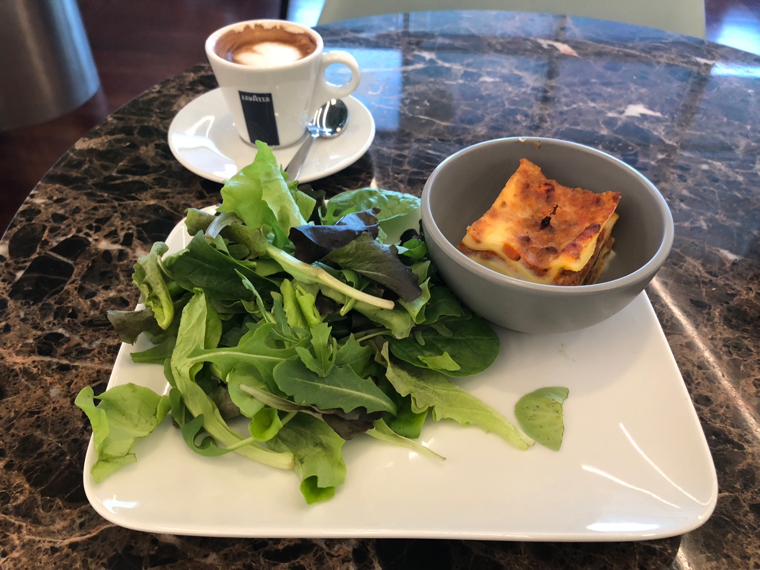 a plate of salad and a cup of coffee