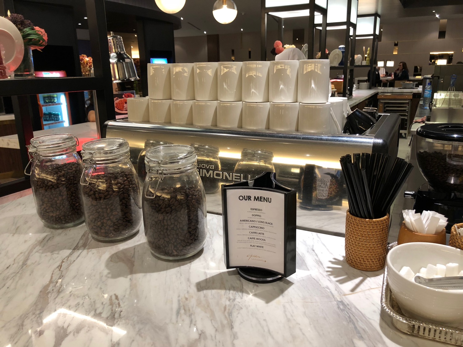 a group of coffee beans and a menu on a counter