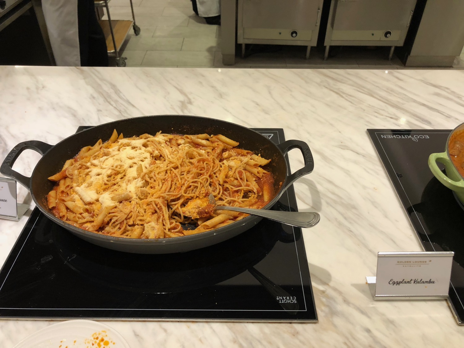 a pan of pasta with cheese and sauce on a stove top