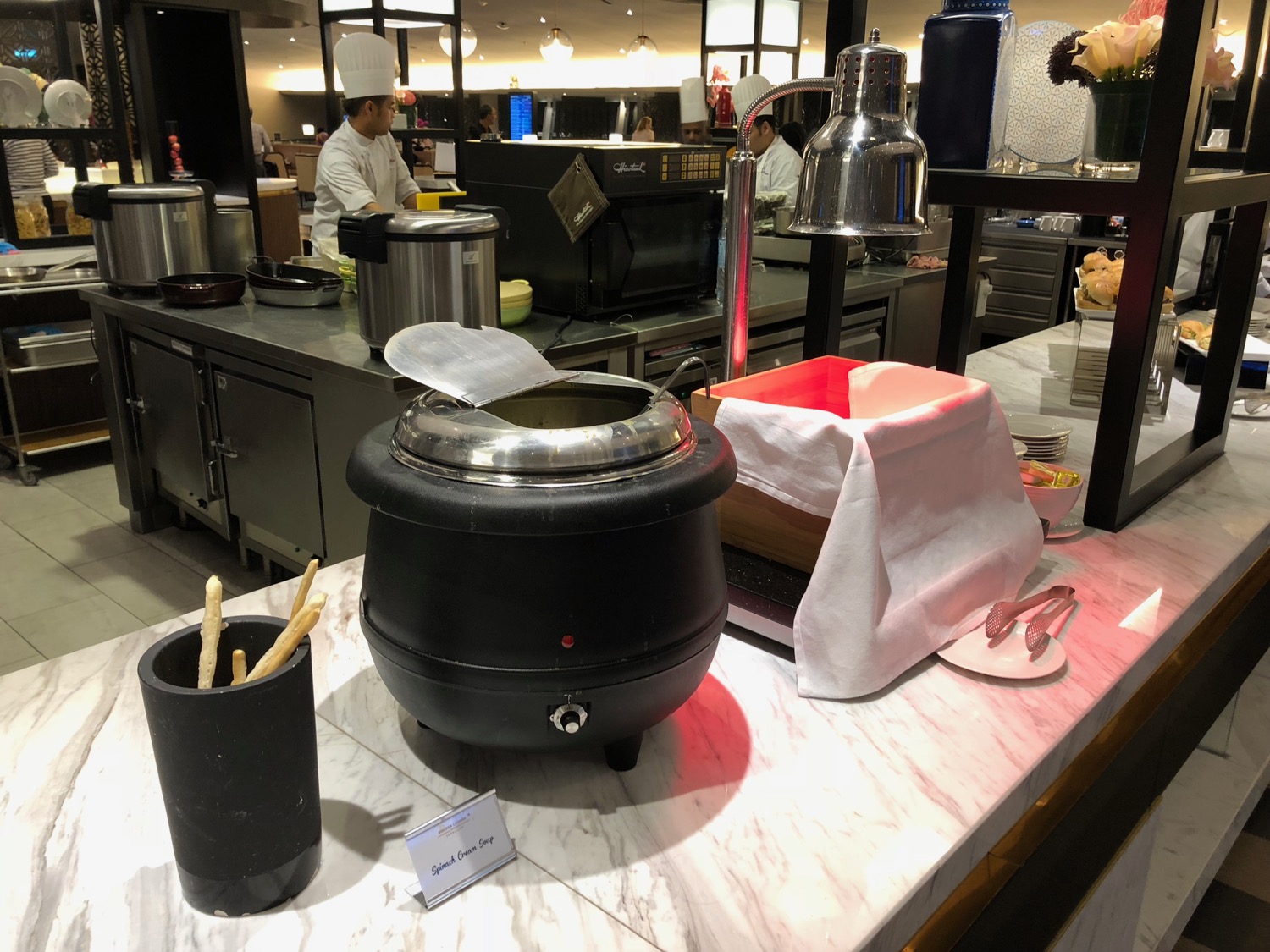 a kitchen with a large black pot and a black container