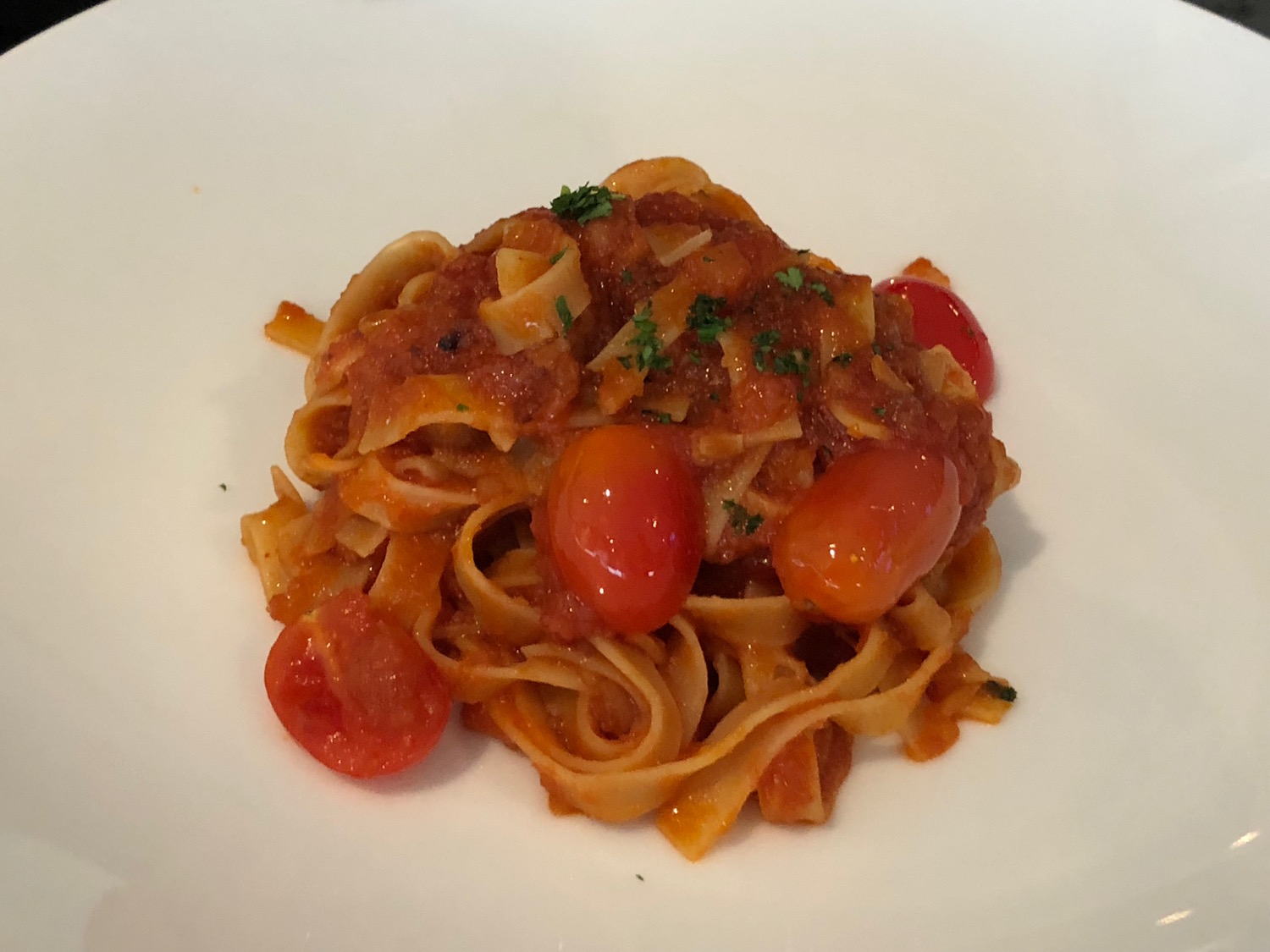 a plate of pasta with tomatoes