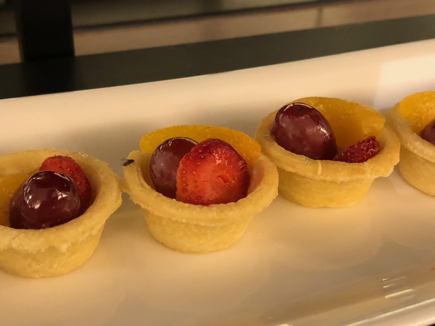 a group of fruit in a small tartlet