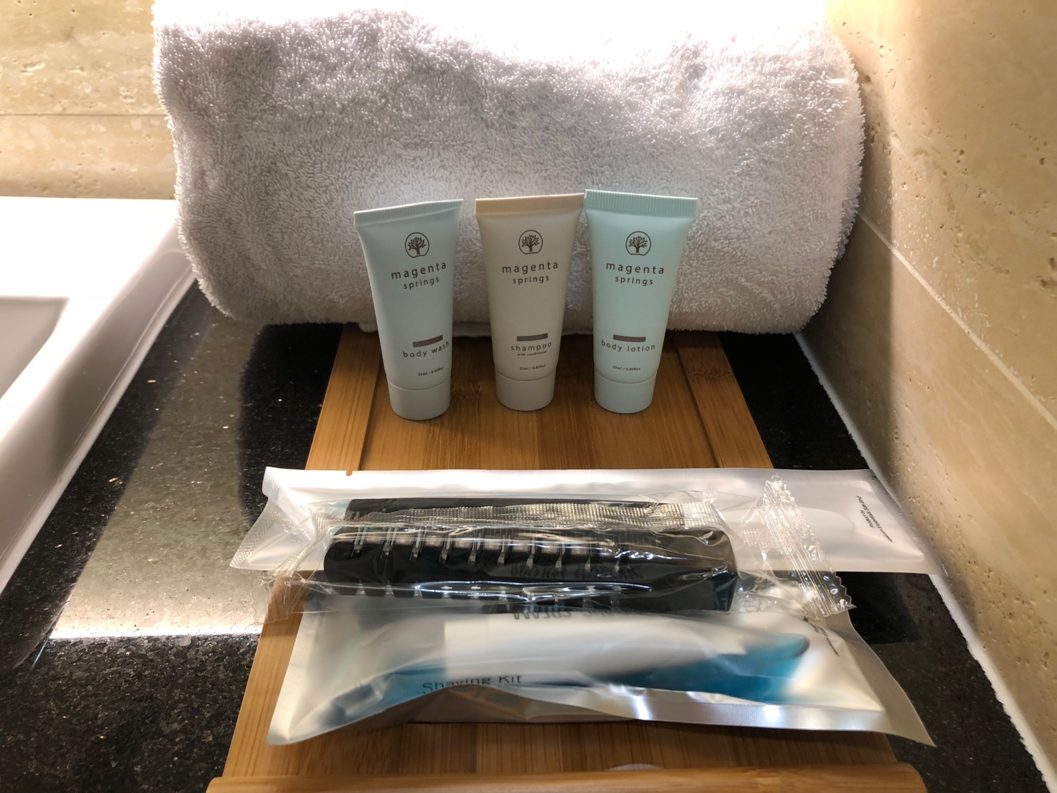 a group of toiletries and a towel on a tray