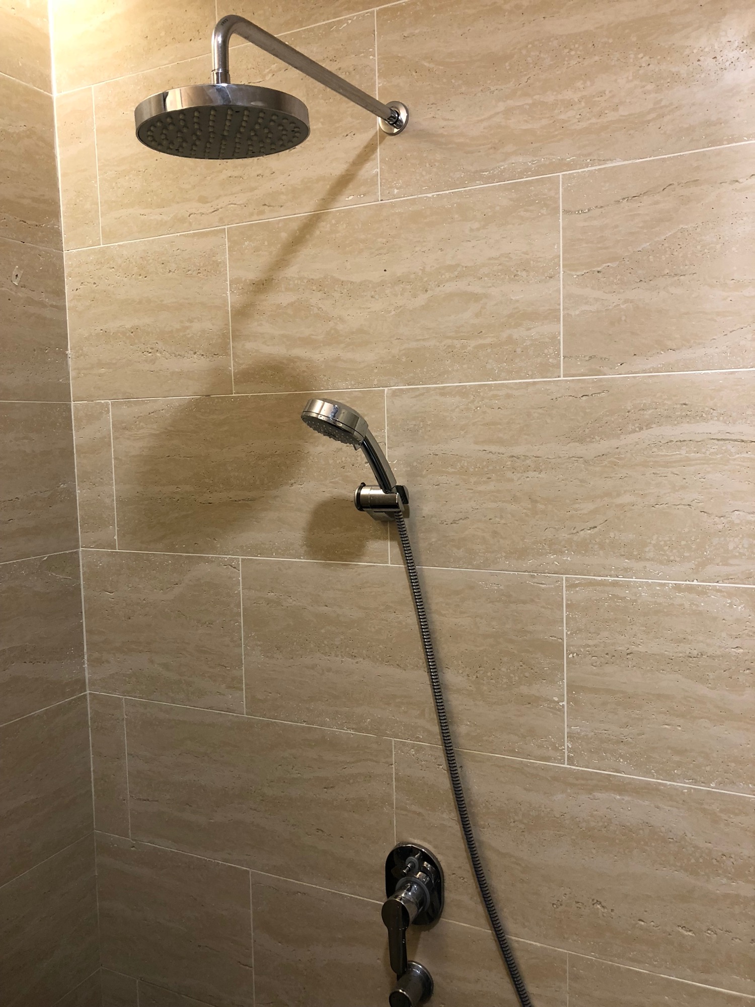 a shower head with a hose attached to the wall