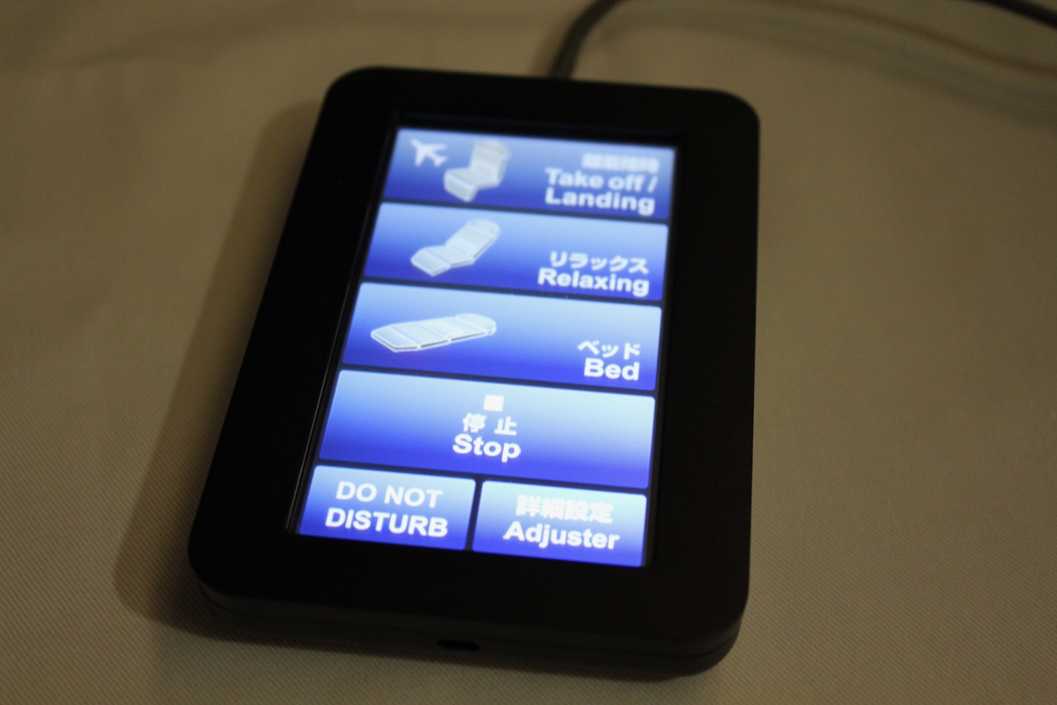 a black rectangular device with blue text on it