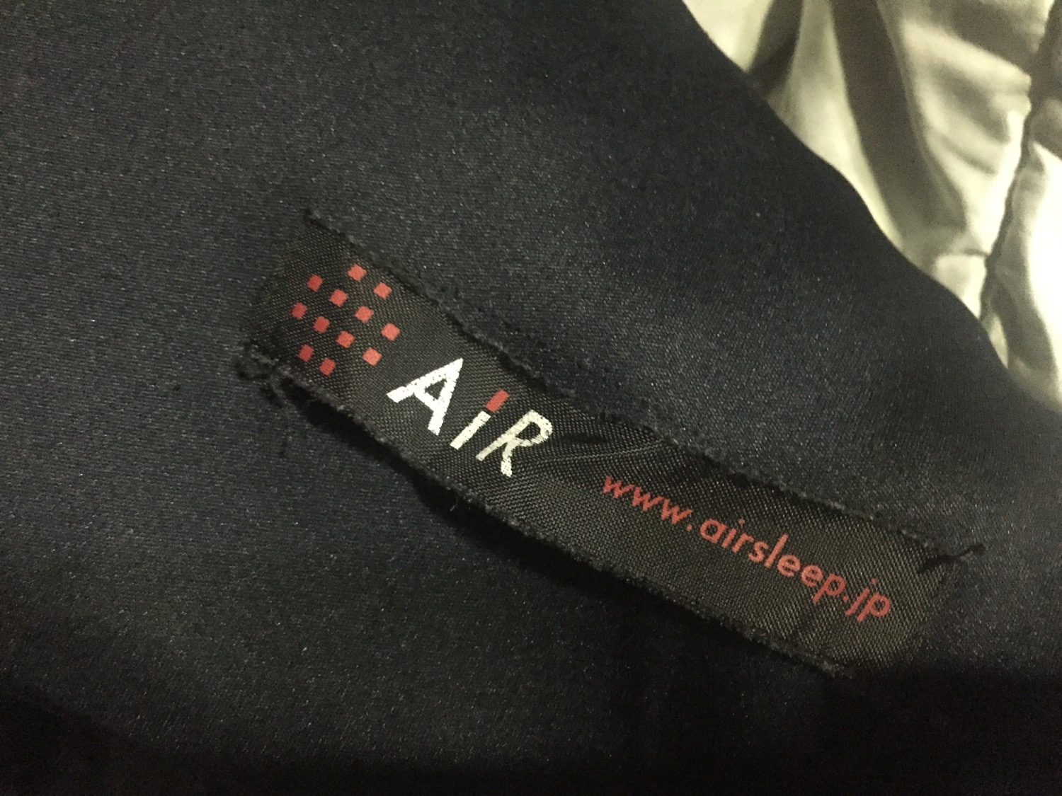a black fabric with white text and red letters on it