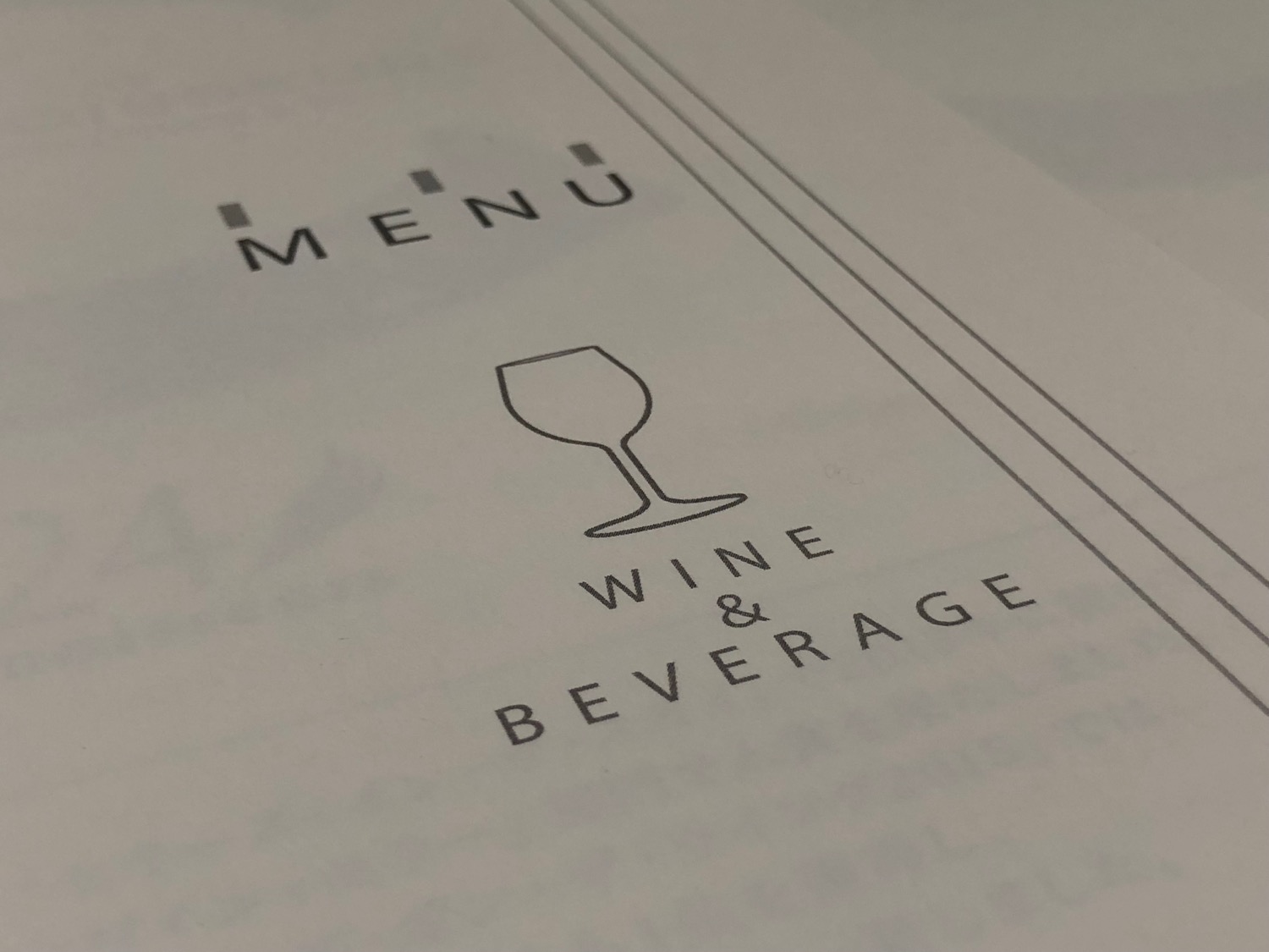 a menu with a wine glass and text