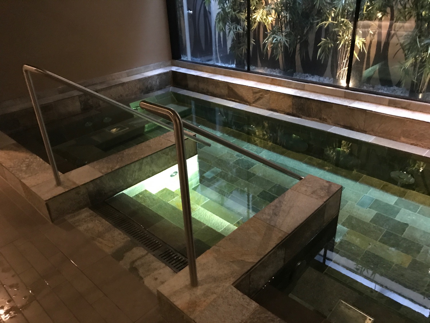 a indoor pool with a metal railing