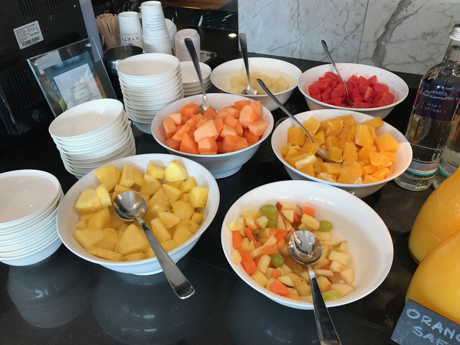a table full of bowls of fruit