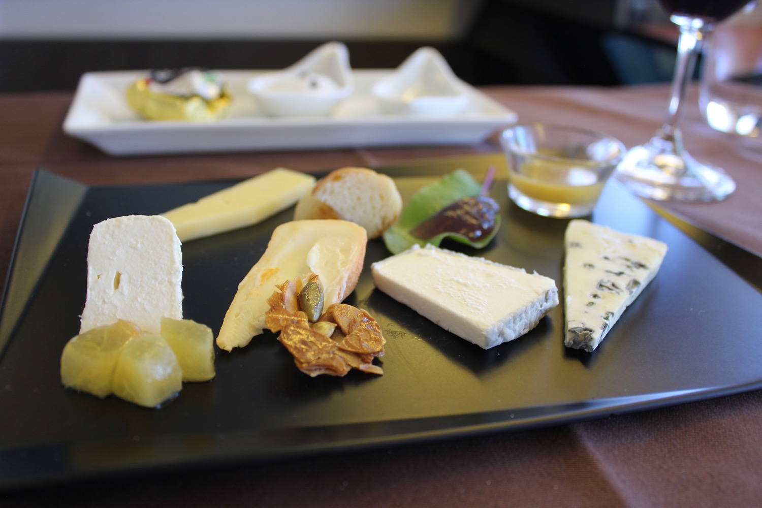 a plate of cheese and other food