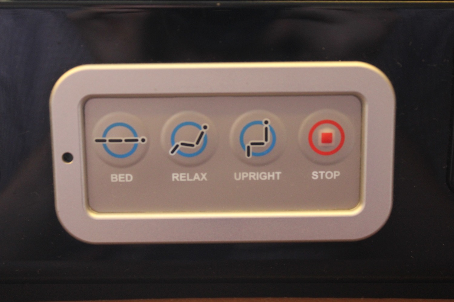 a white rectangular button with blue and red text
