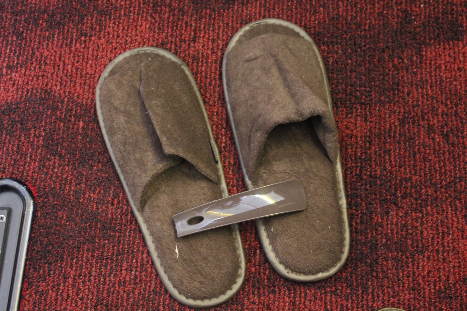 a pair of slippers on a red carpet