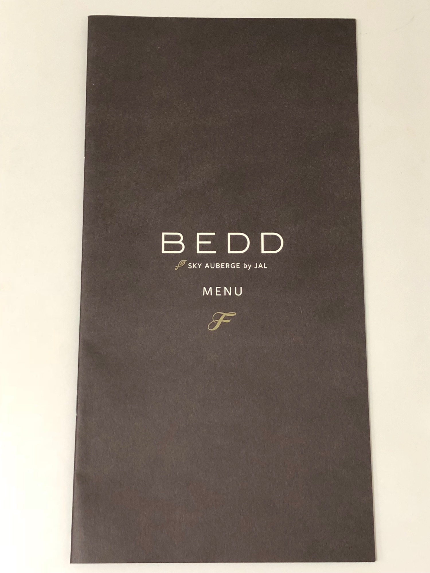 a brown menu with gold text