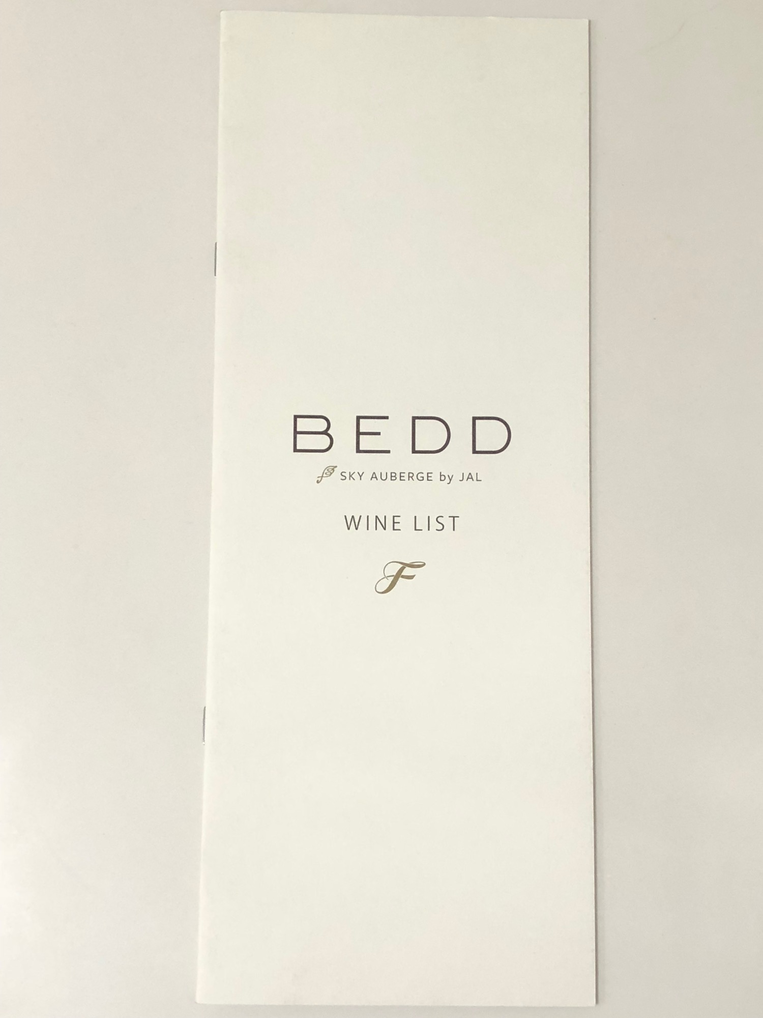 a white menu with gold text