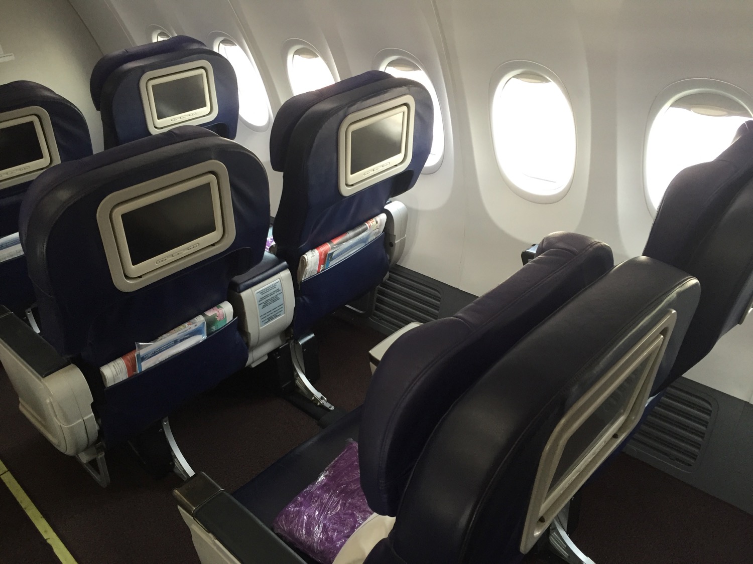 seats in an airplane with windows