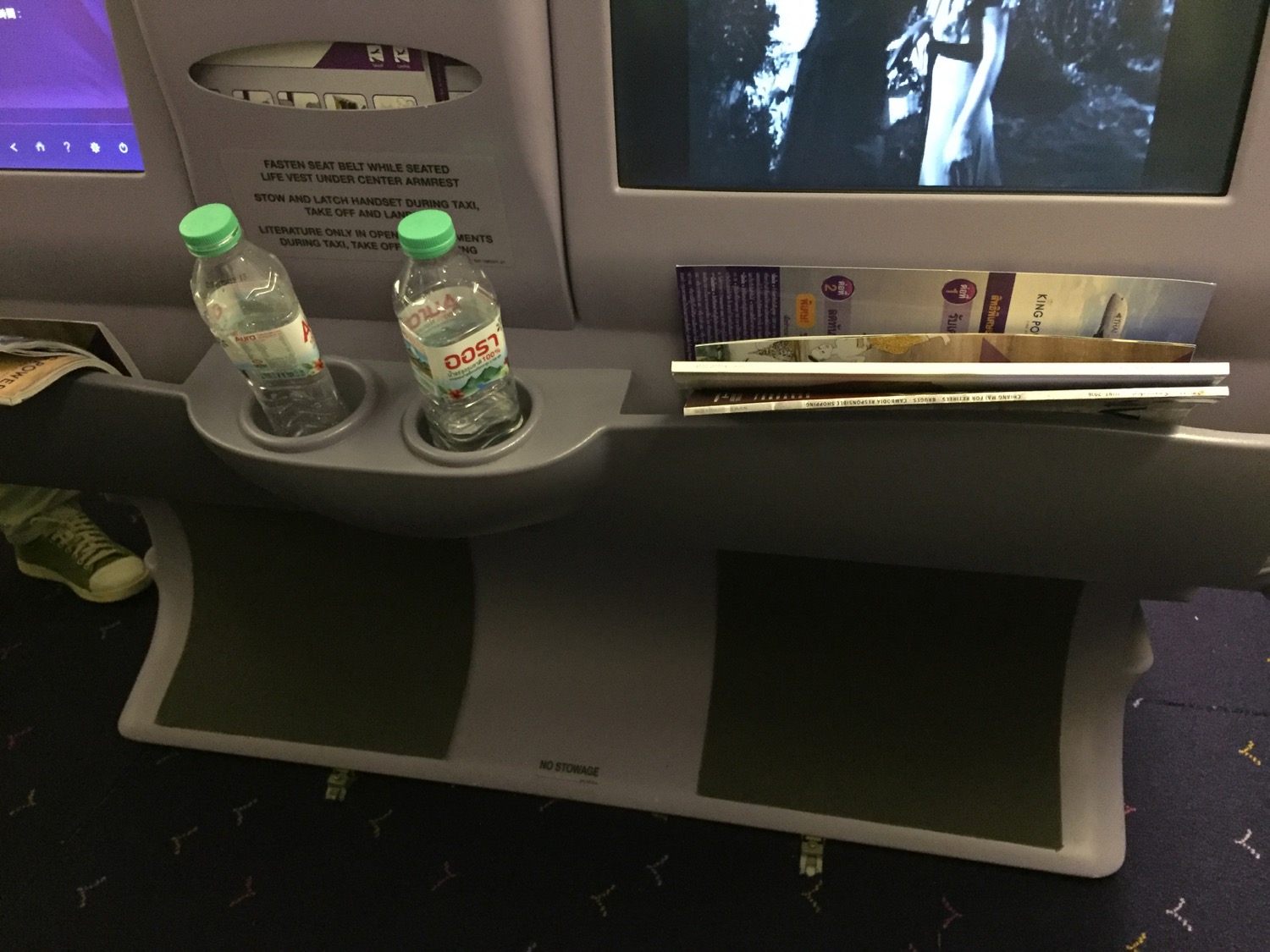 a seat with a tv and a couple of bottles