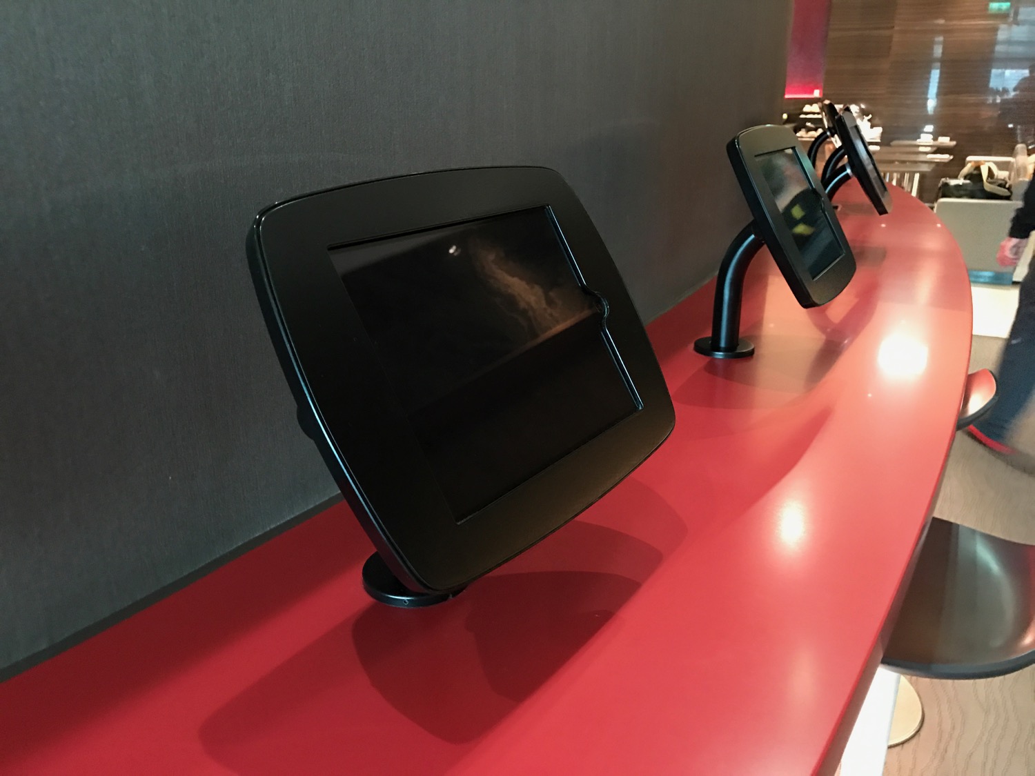 a row of black electronic devices on a red surface
