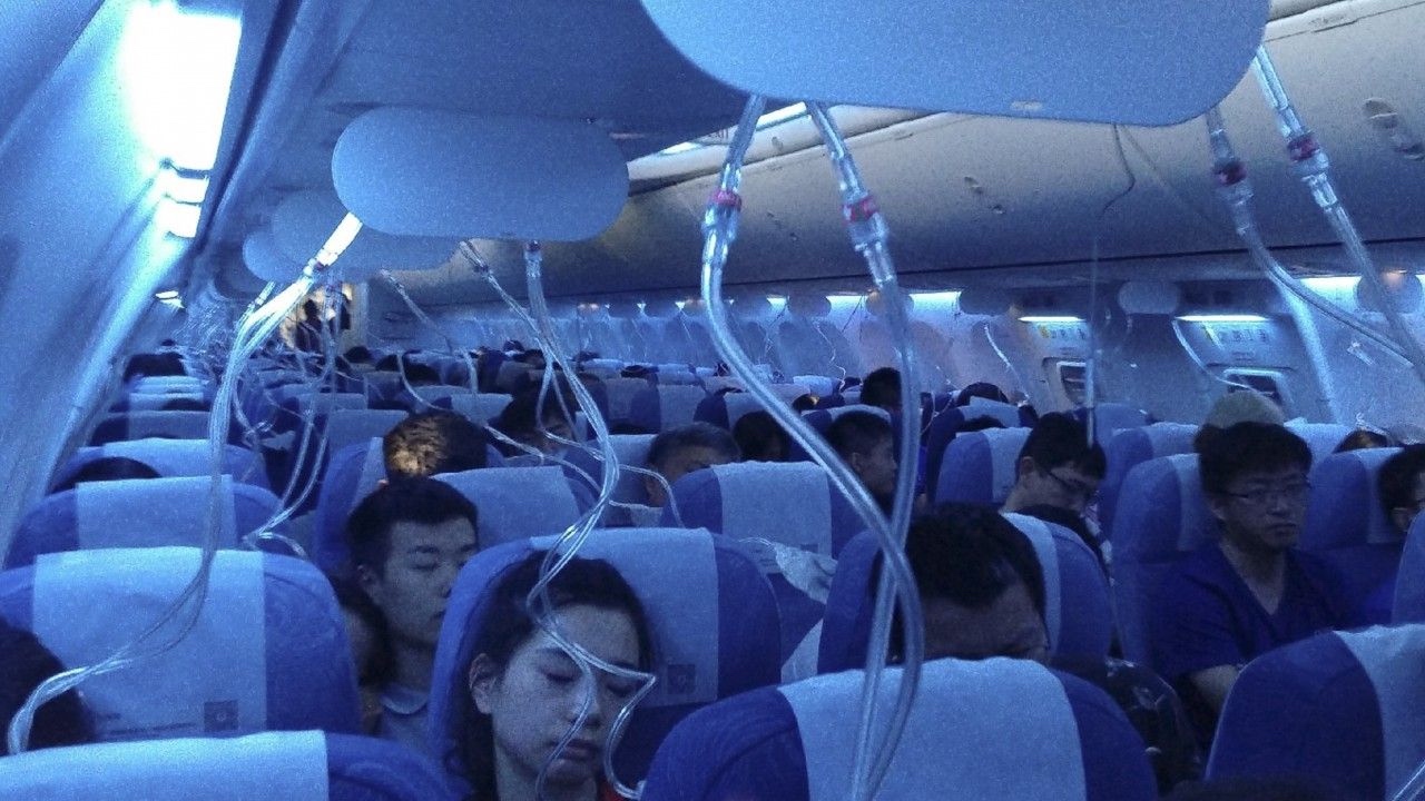 a group of people sleeping on an airplane
