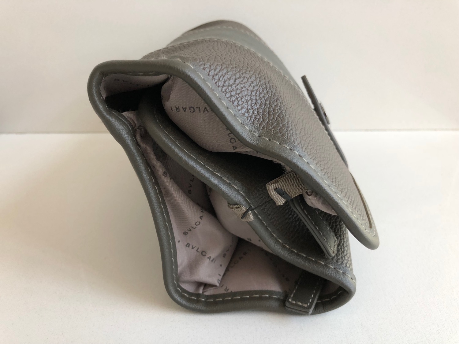 a grey purse with a zipper