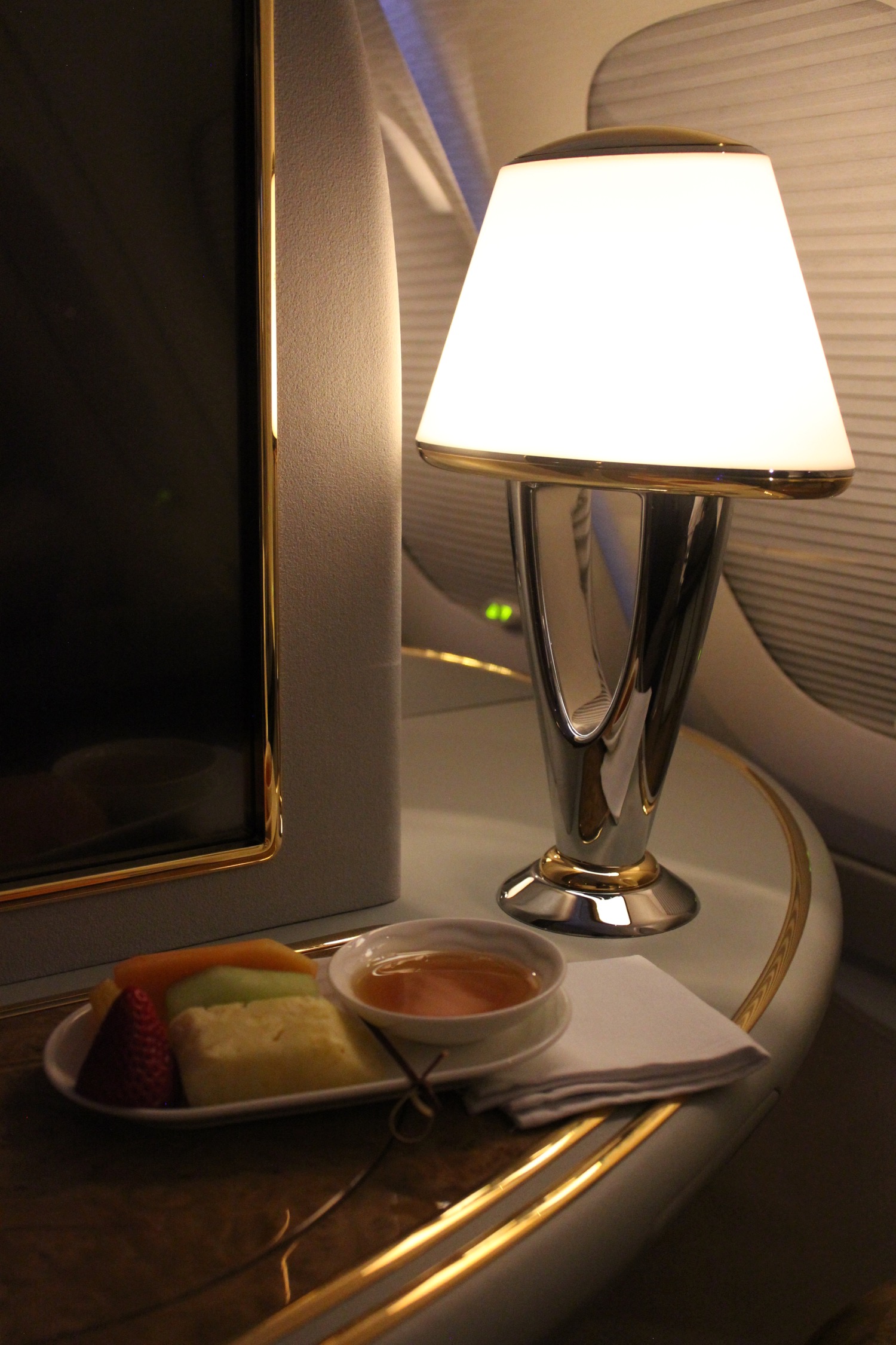 a lamp on a table next to a plate of food