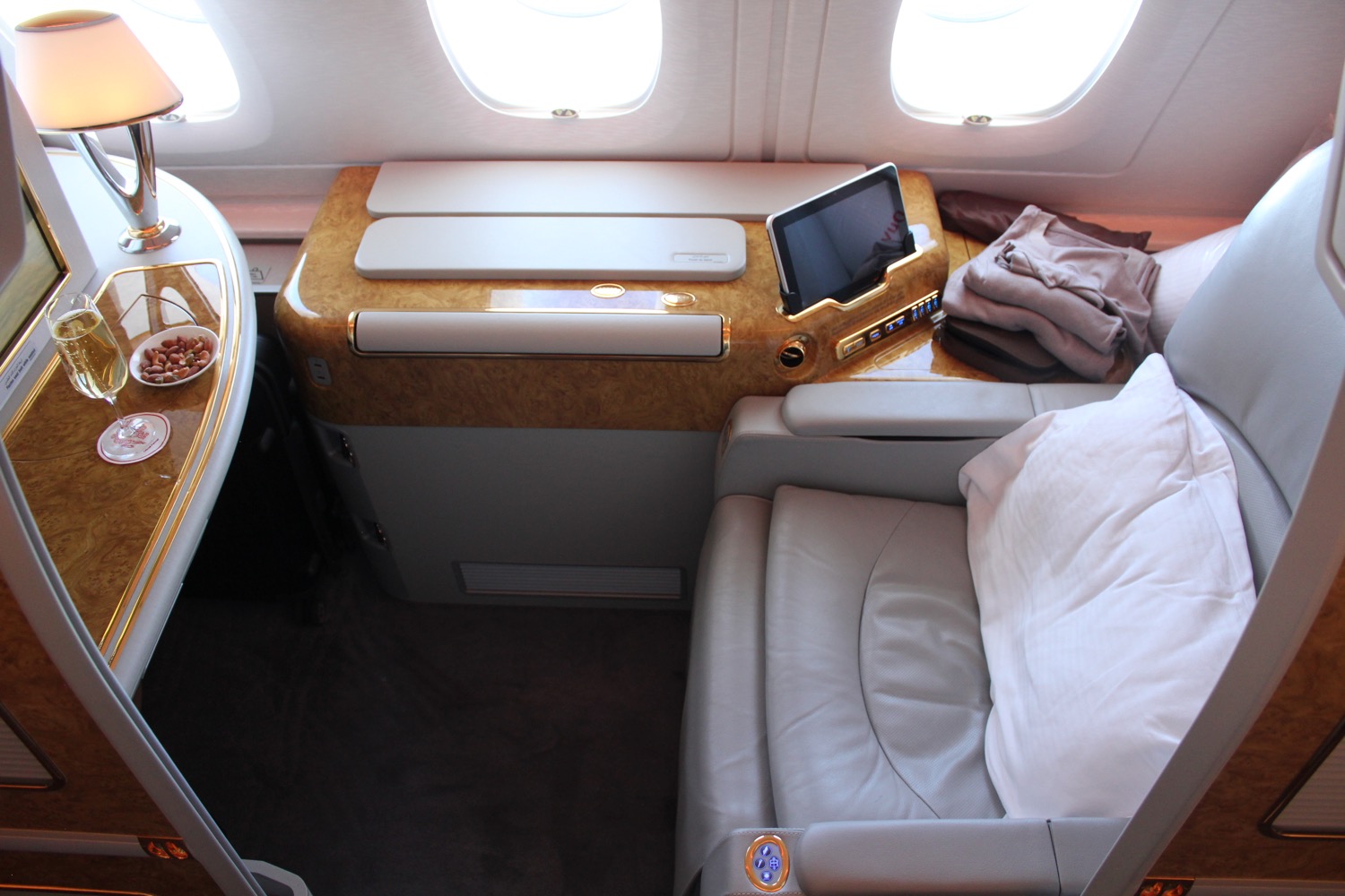 a seat with a bed and a tablet on the side