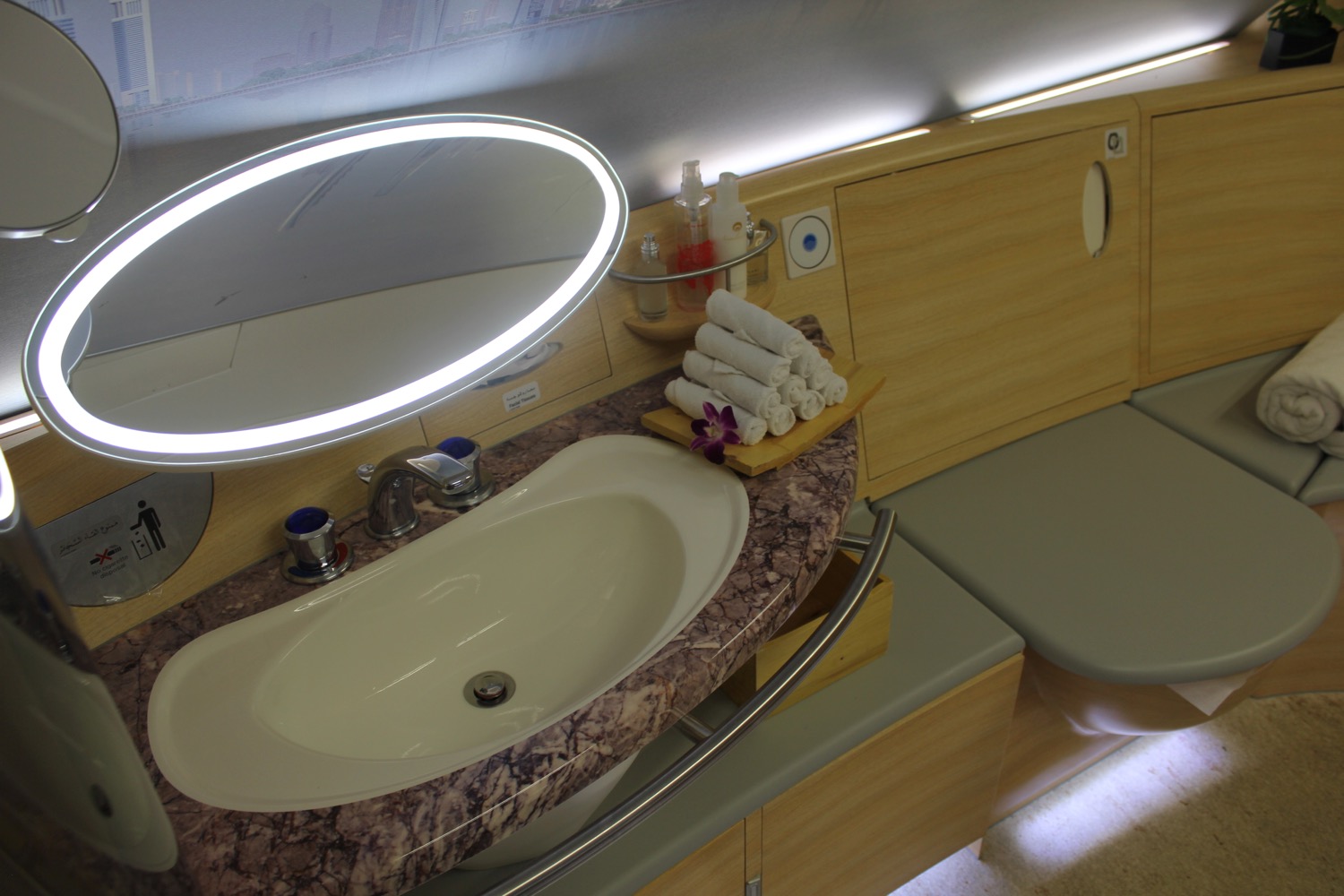 a sink with a round mirror